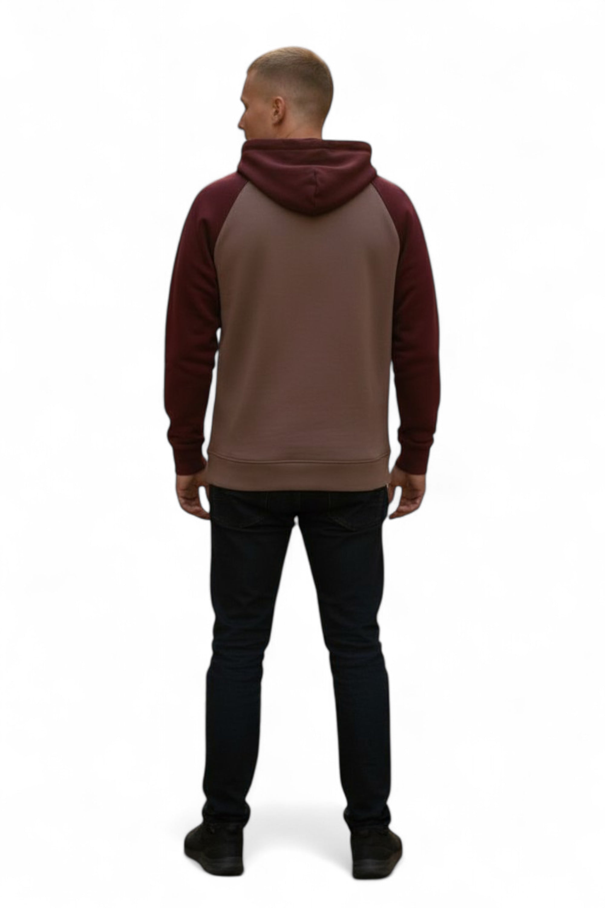 Person wearing a brown and red hoodie with black pants on a white background