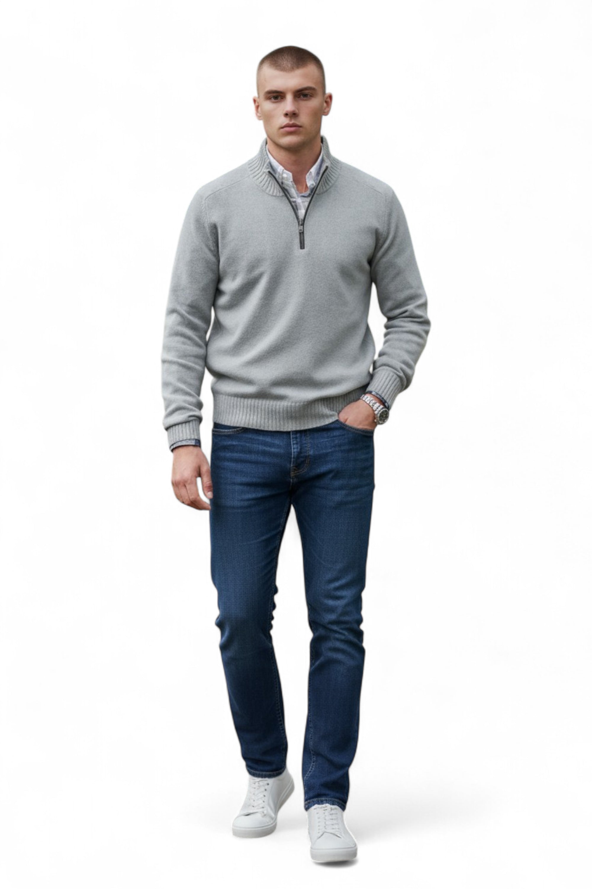 Man wearing a gray sweater and blue jeans on a white background