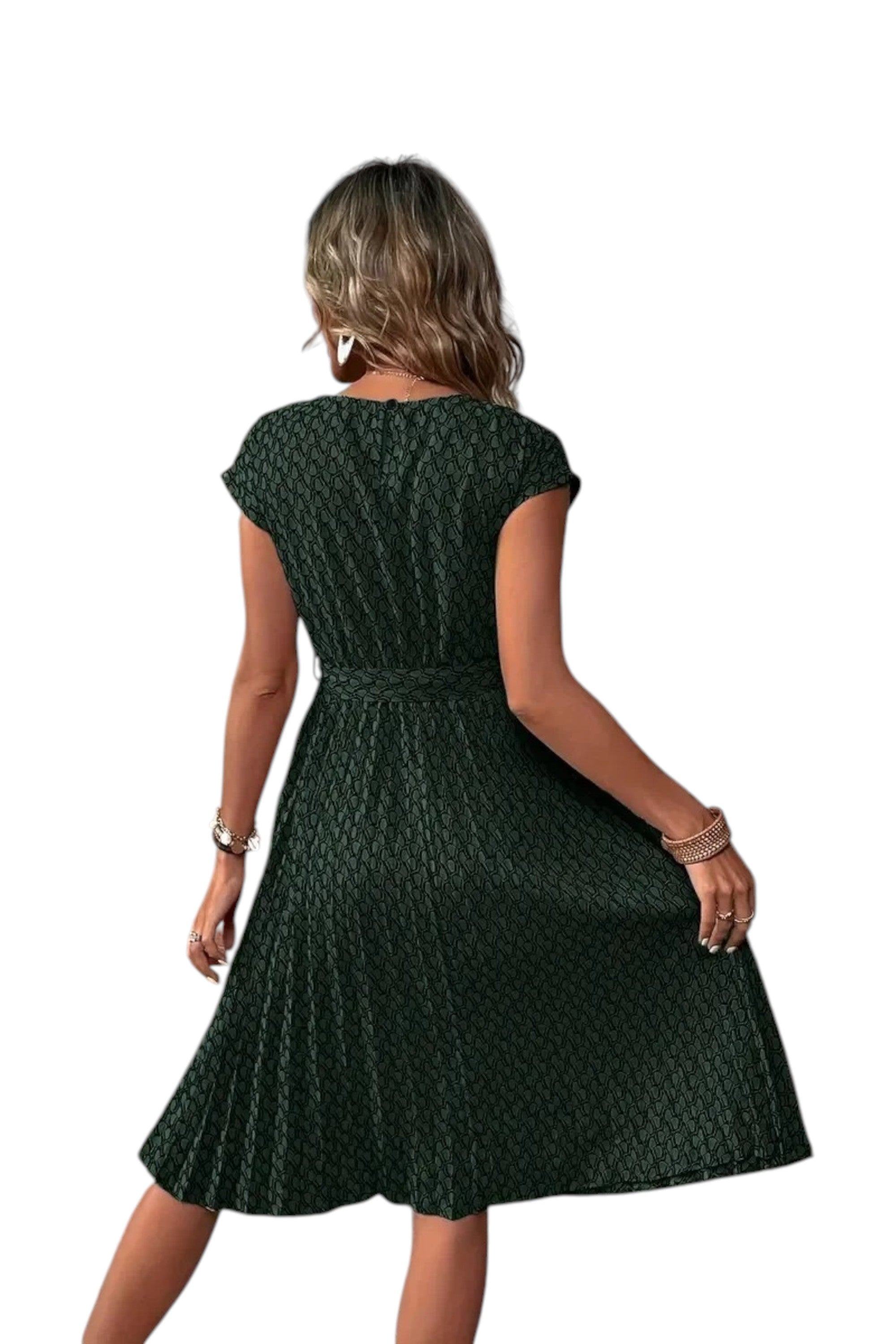 Woman wearing a green patterned dress on a white background