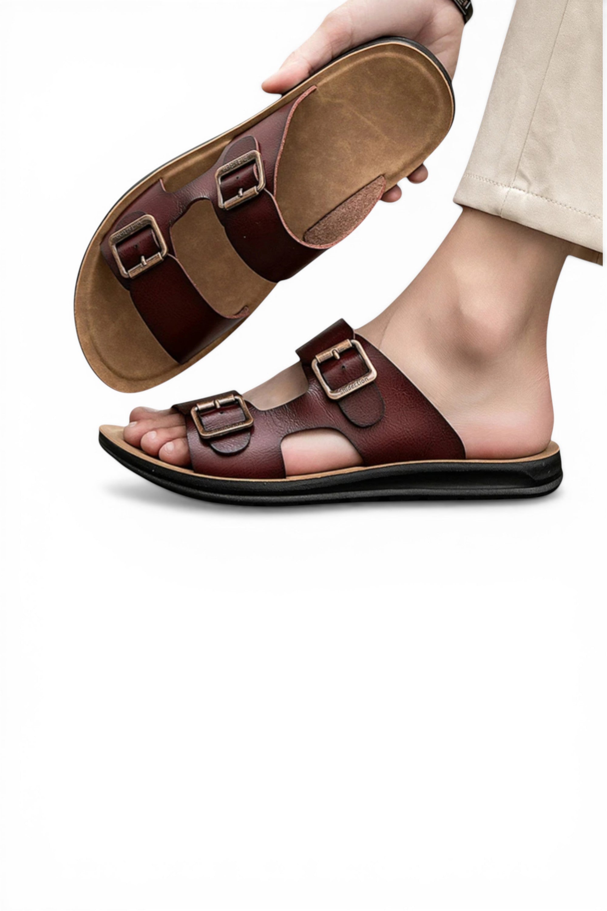 Brown sandals with buckles worn by a person on a white background