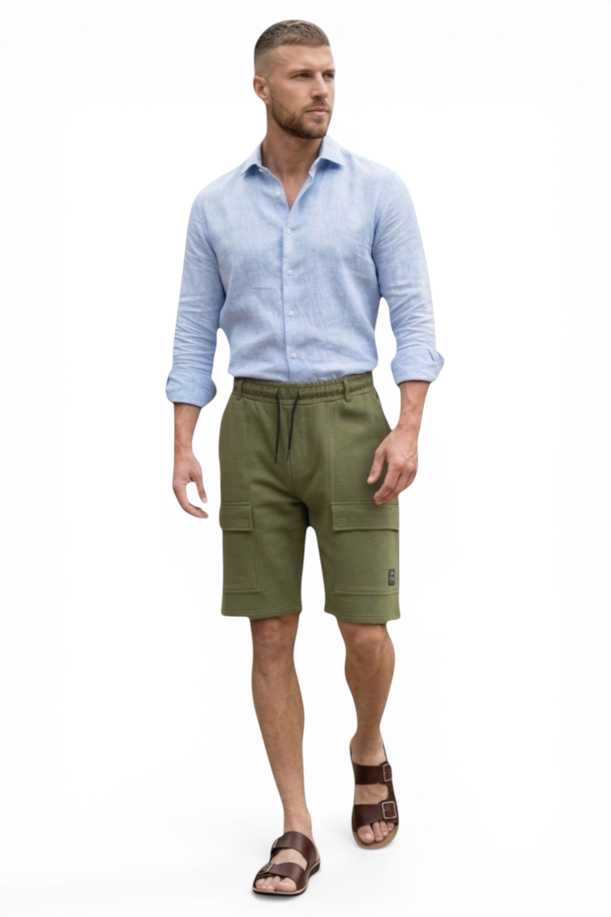 Man wearing a light blue shirt and green cargo shorts on a white background