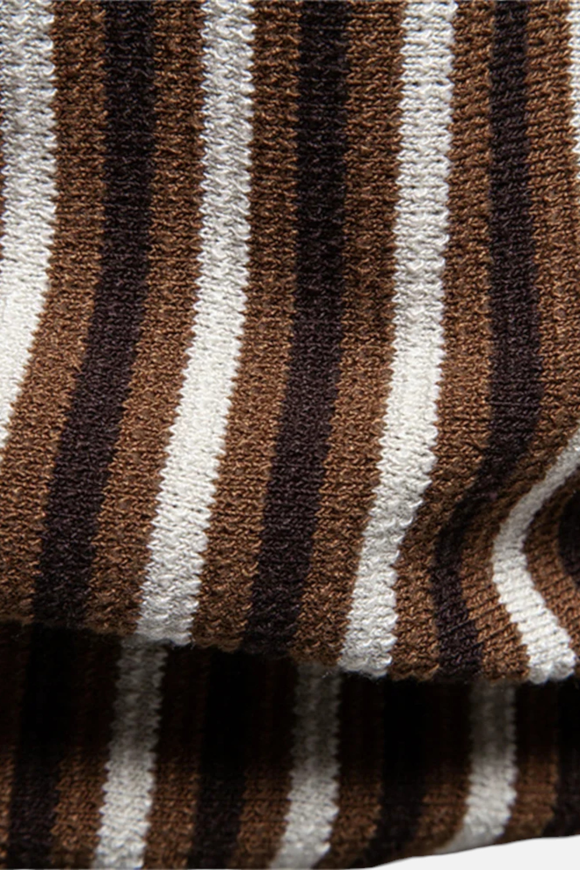 Close-up of a striped fabric with brown, black, and white colors.