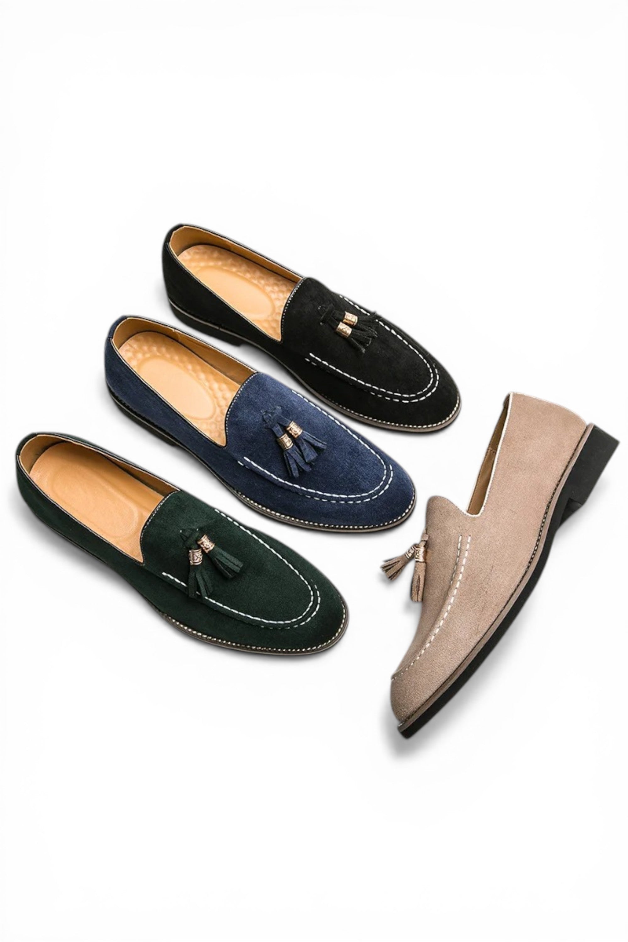 Four loafers in black, navy, green, and beige on a white background