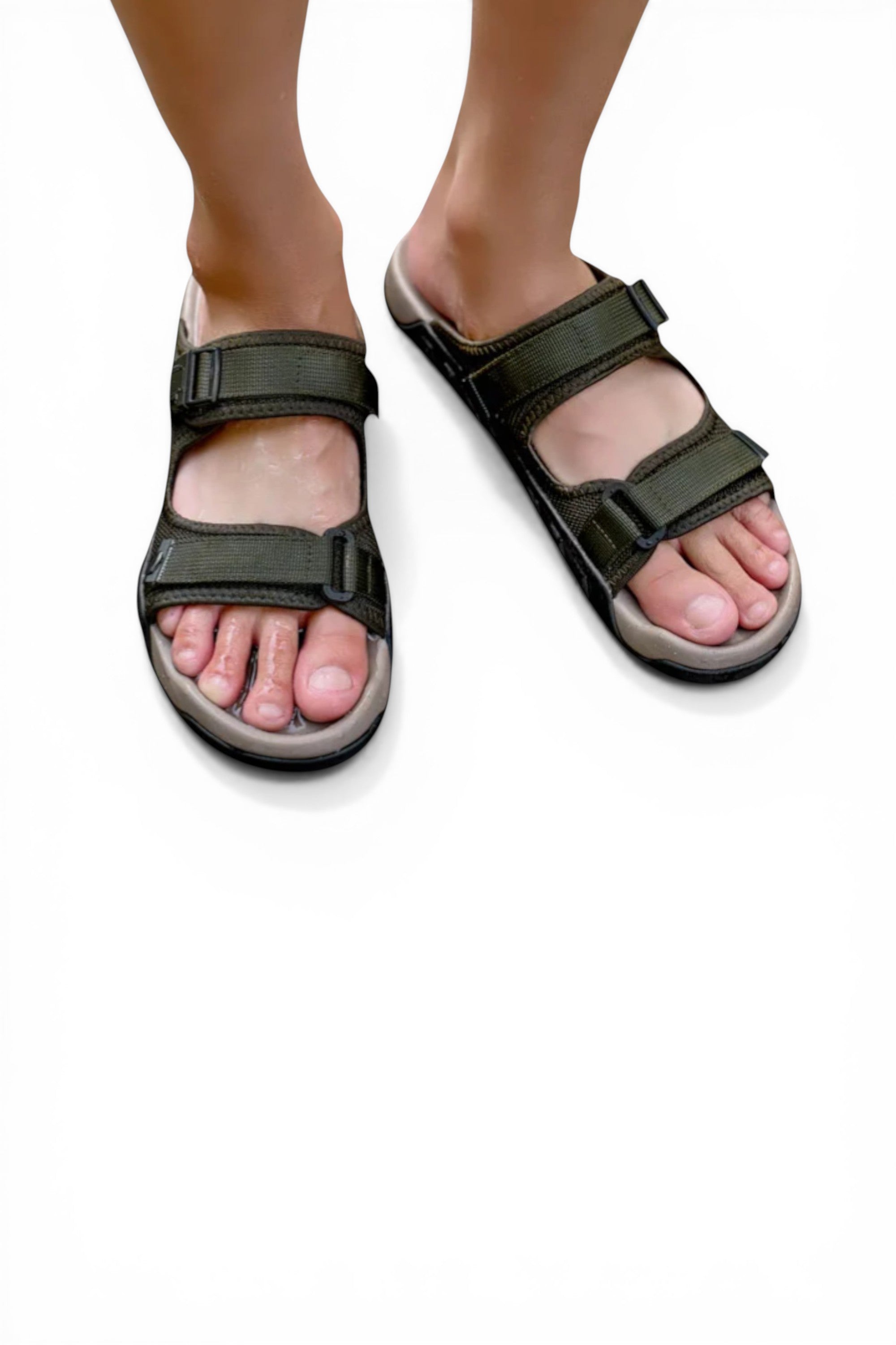 Green sandals worn by a person on a white background