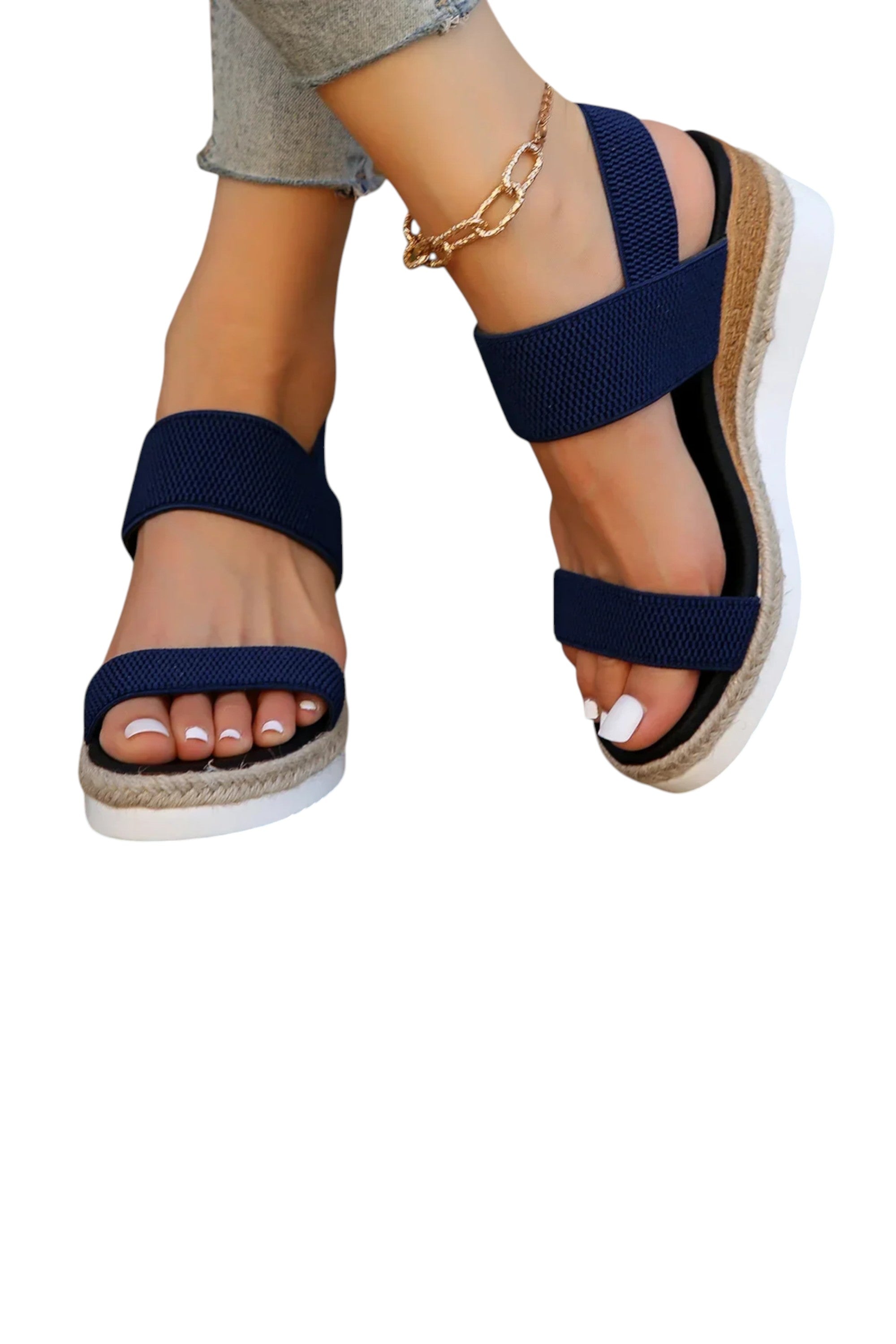 Navy blue sandals with a white sole worn by a person on a white background
