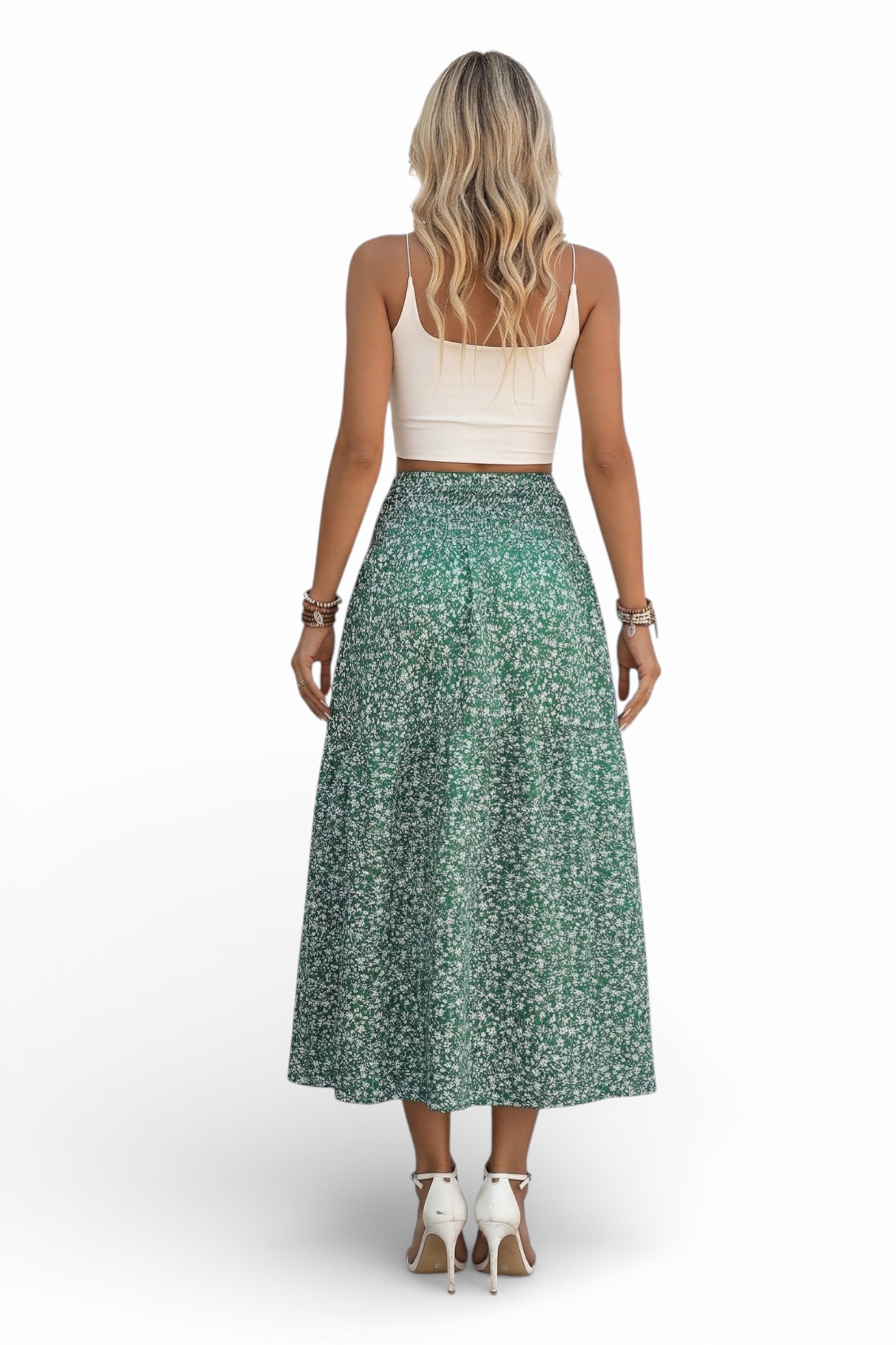 Woman wearing a white top and green floral skirt on a white background