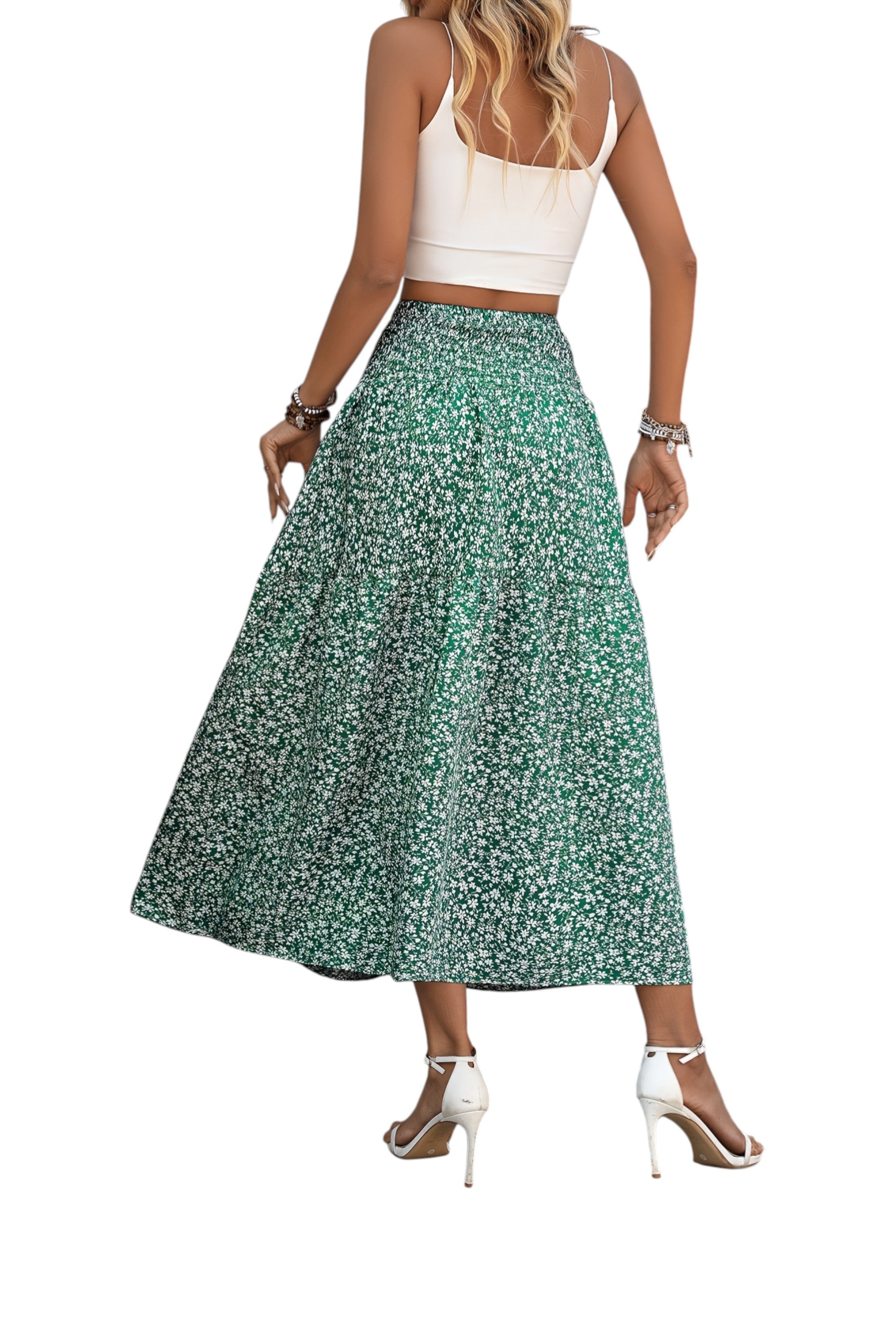 Woman wearing a white top and green floral skirt on a white background