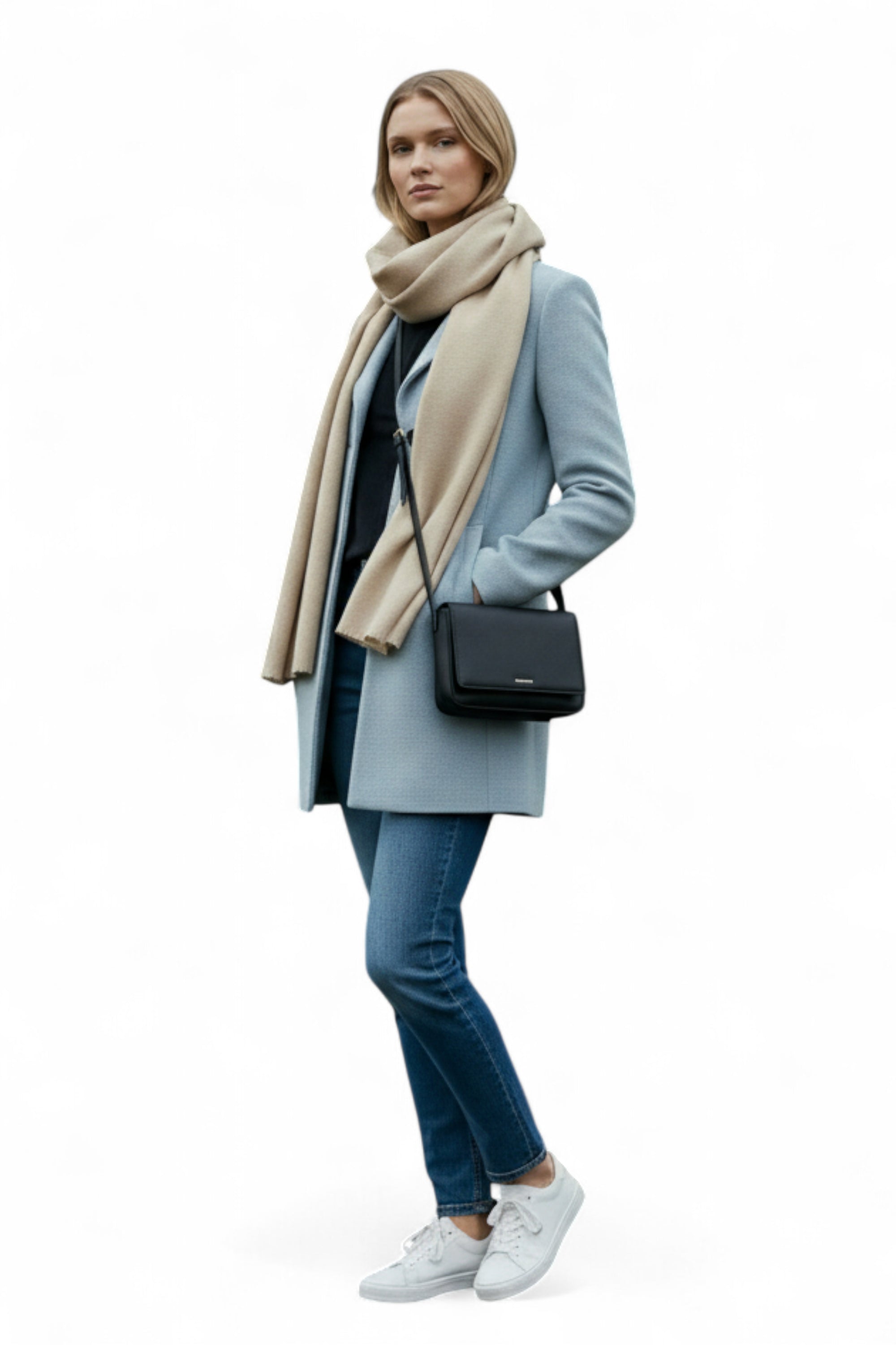 Woman wearing a light blue coat, beige scarf, and carrying a black handbag on a white background