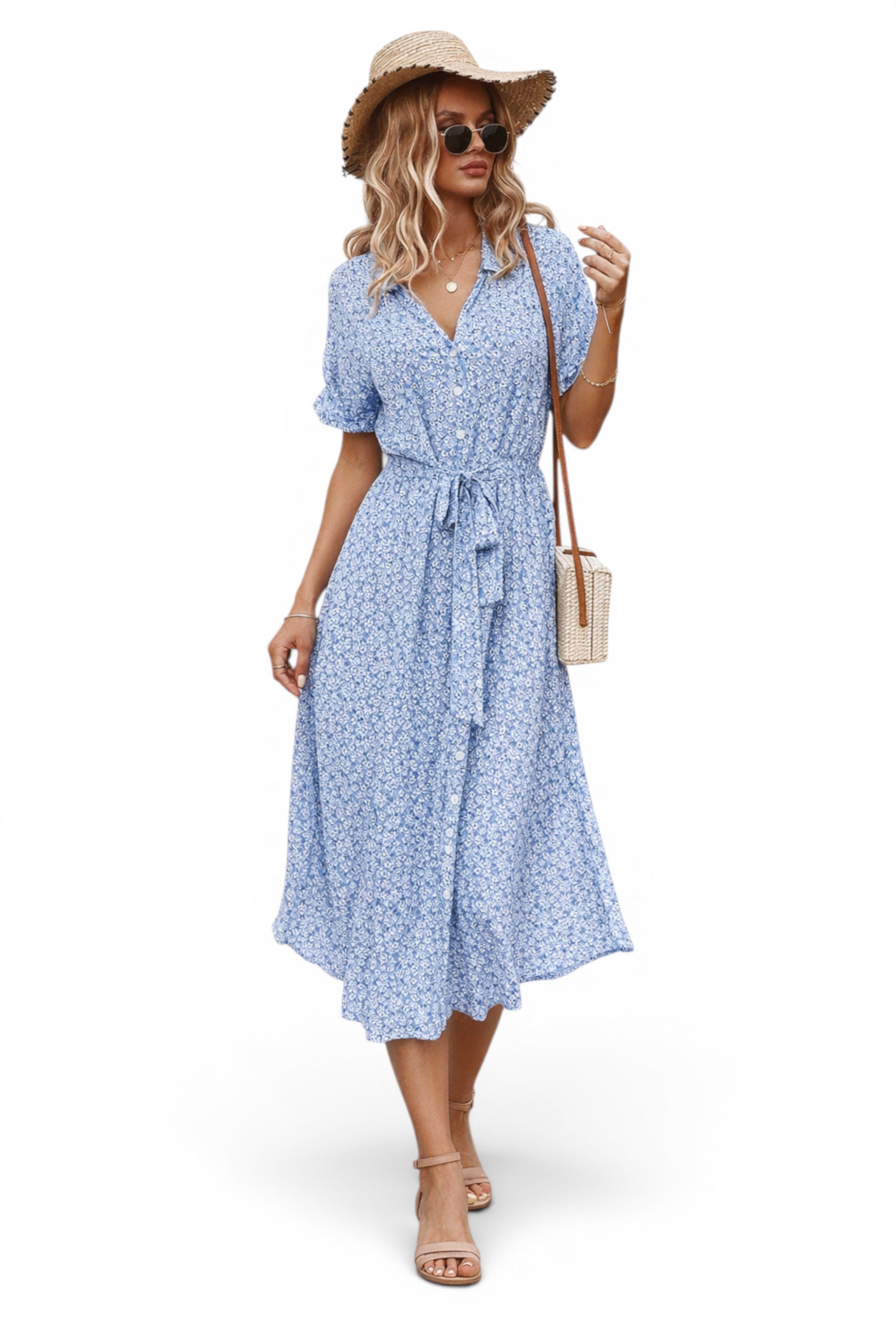 Woman wearing a blue floral dress with a hat and sunglasses on a white background
