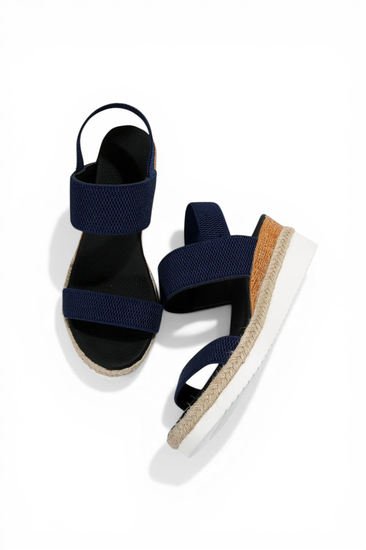 Navy blue sandals with cork sole on a white background