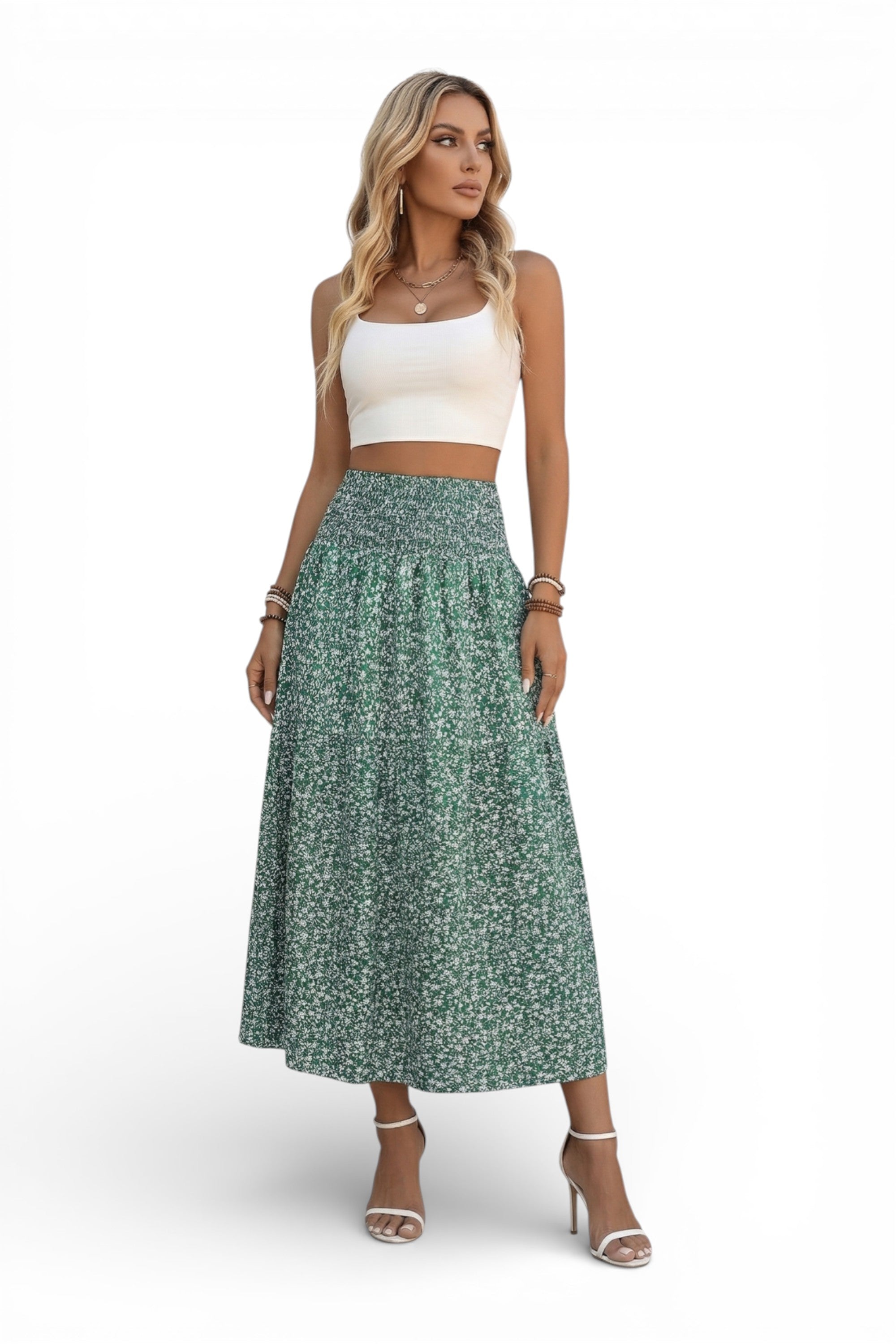 Woman wearing a white top and green floral skirt on a white background