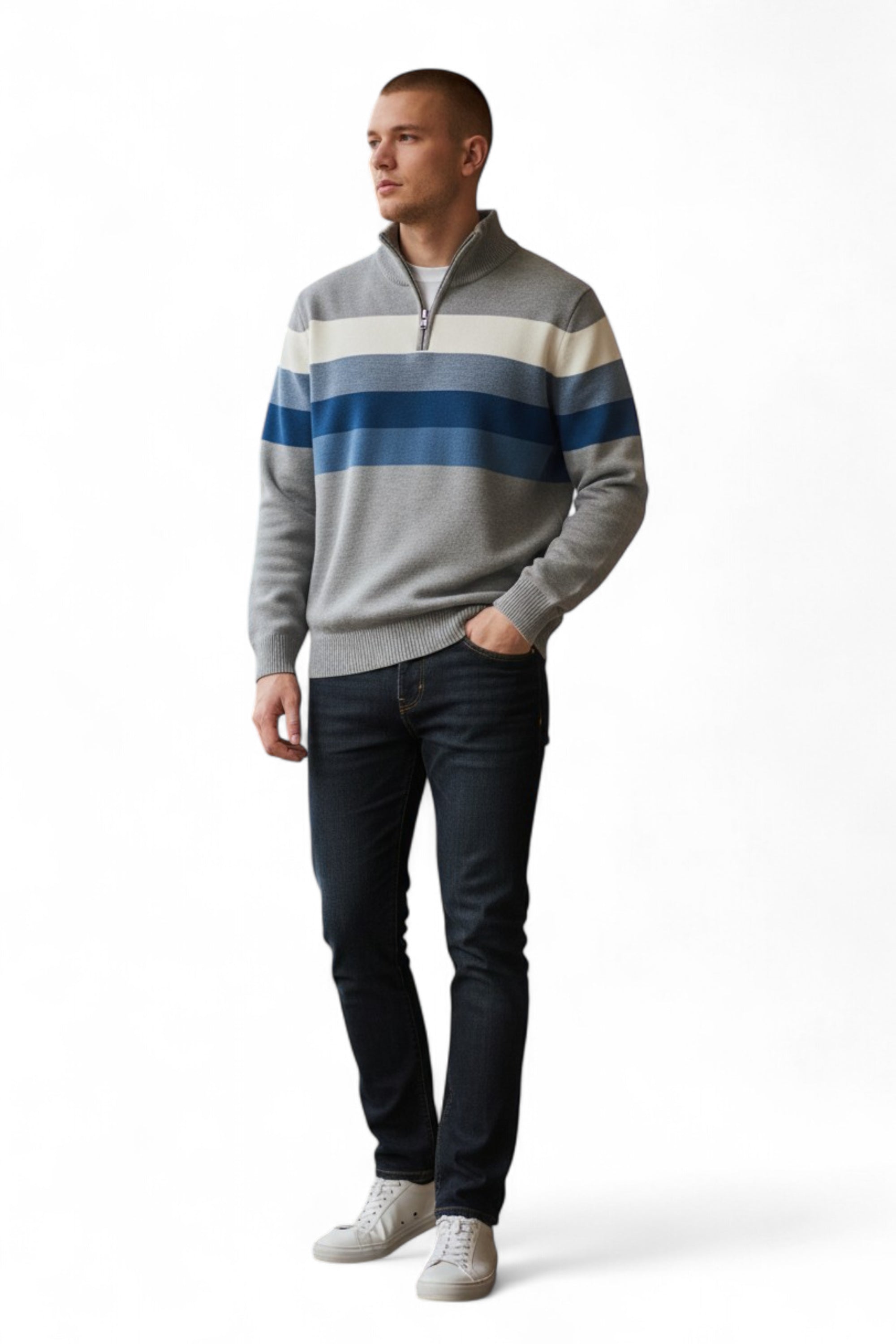 Man wearing a striped sweater and jeans on a white background