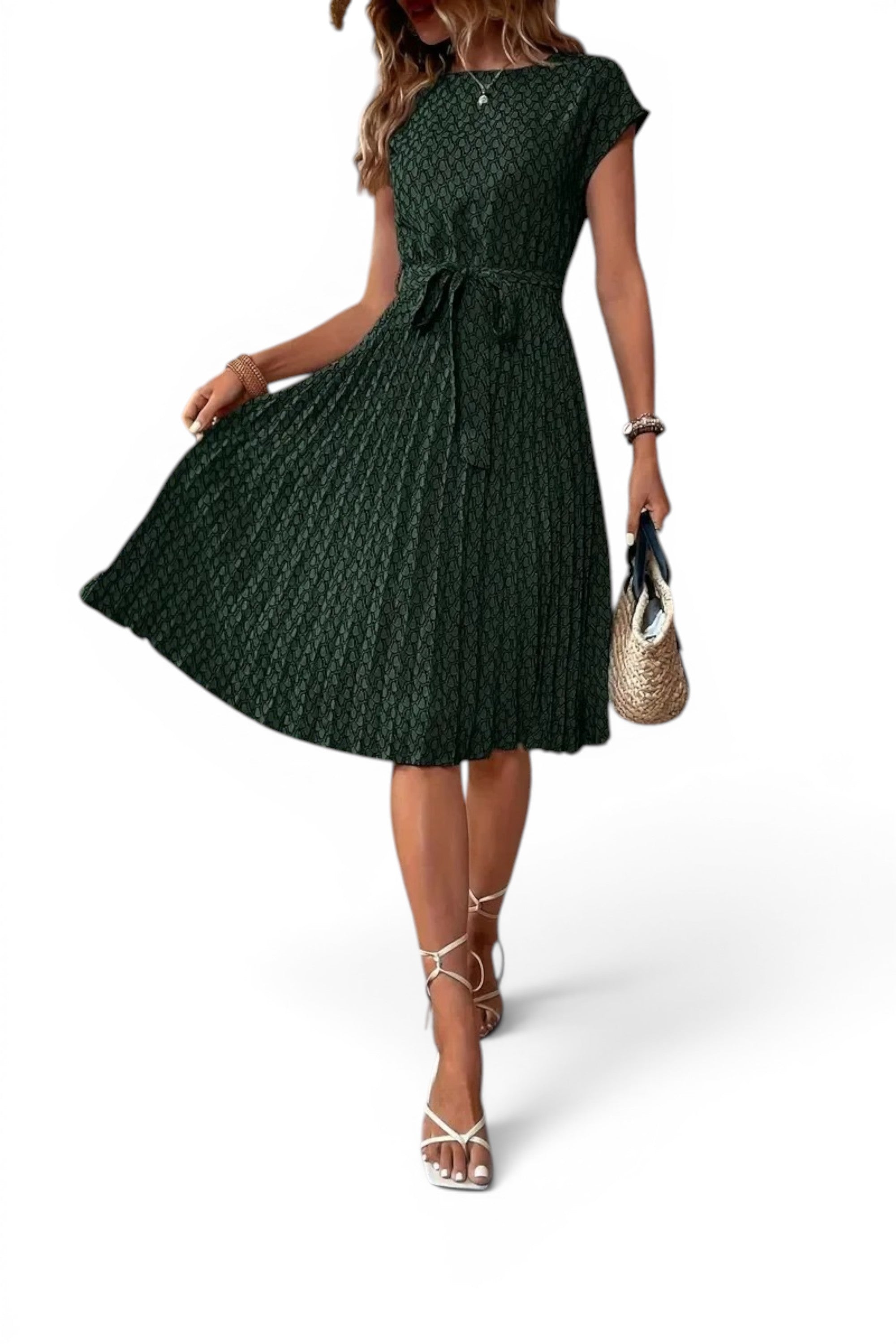 Woman wearing a green patterned dress on a white background
