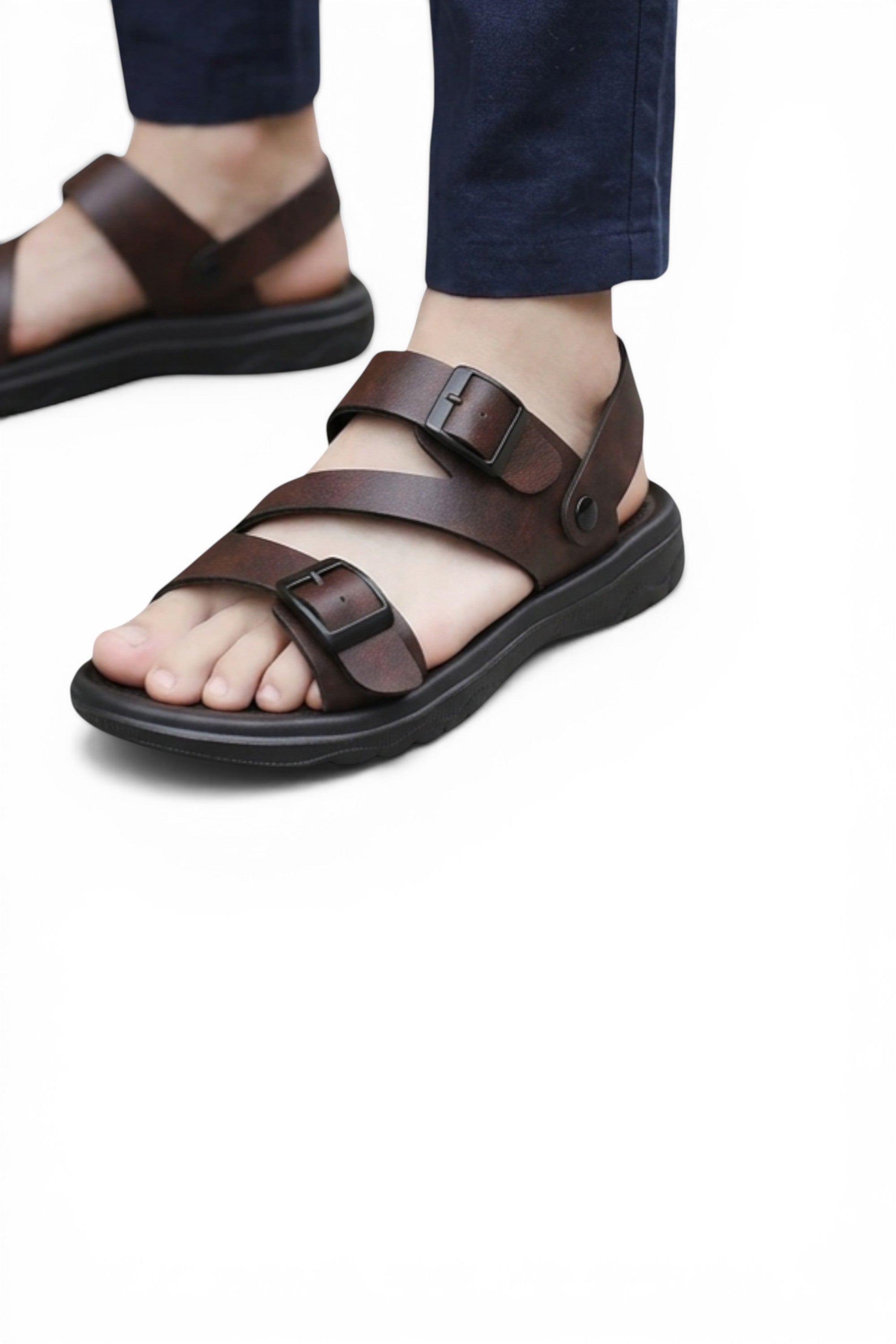 Brown sandals worn with navy pants on a white background