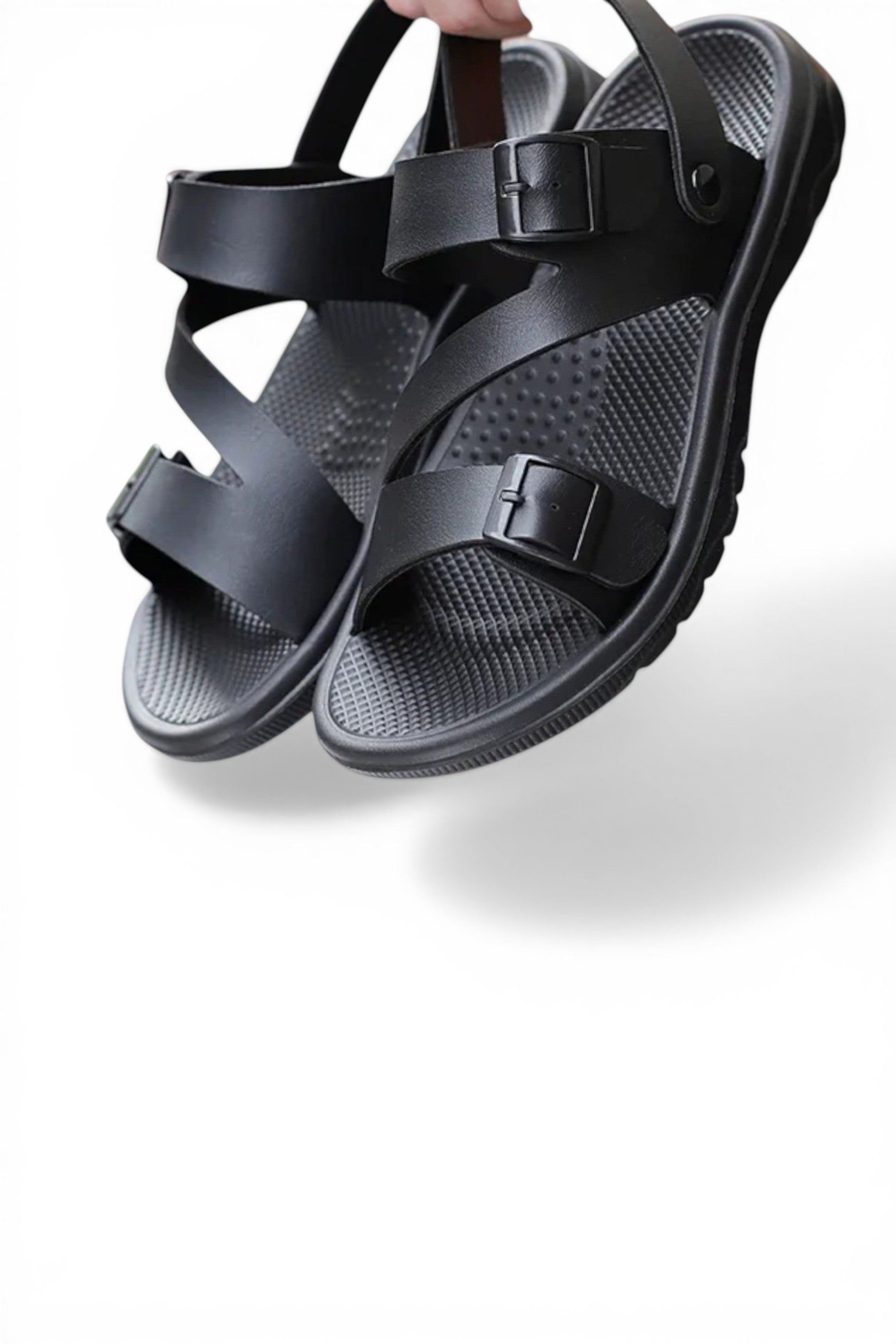 Black sandals with adjustable straps on a white background