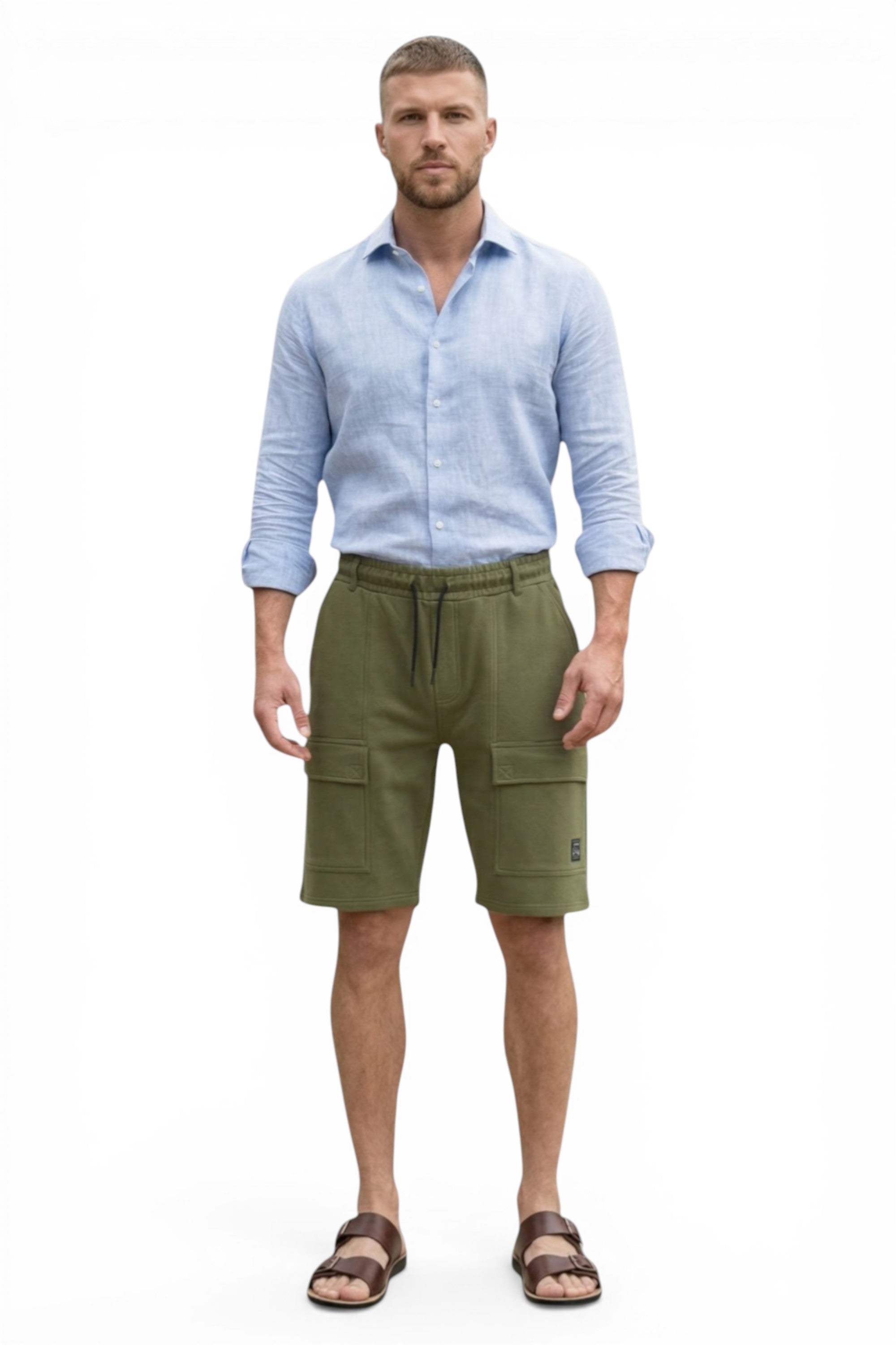 Man wearing a light blue shirt and green cargo shorts on a white background