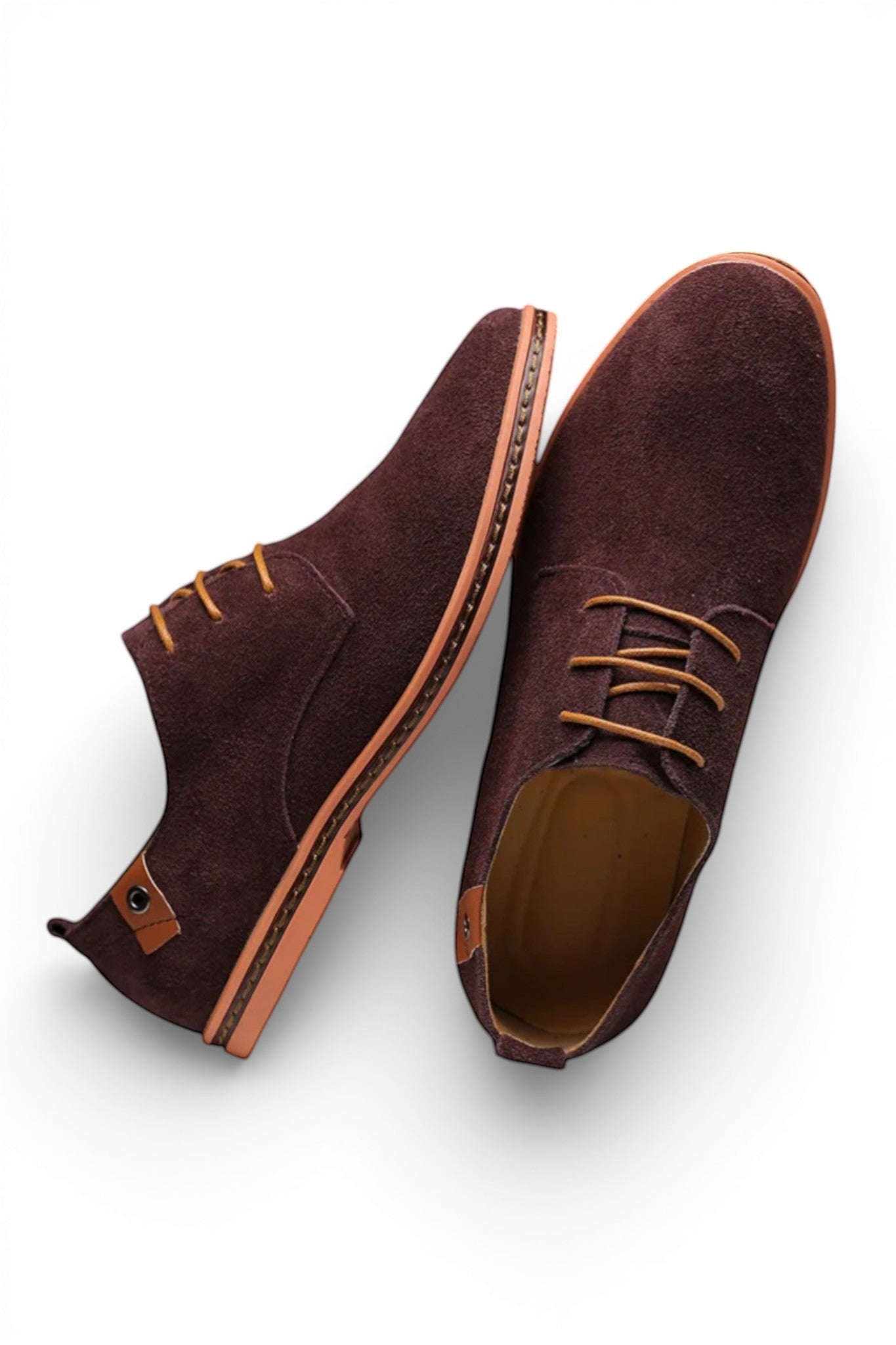 Pair of brown suede shoes on a white background