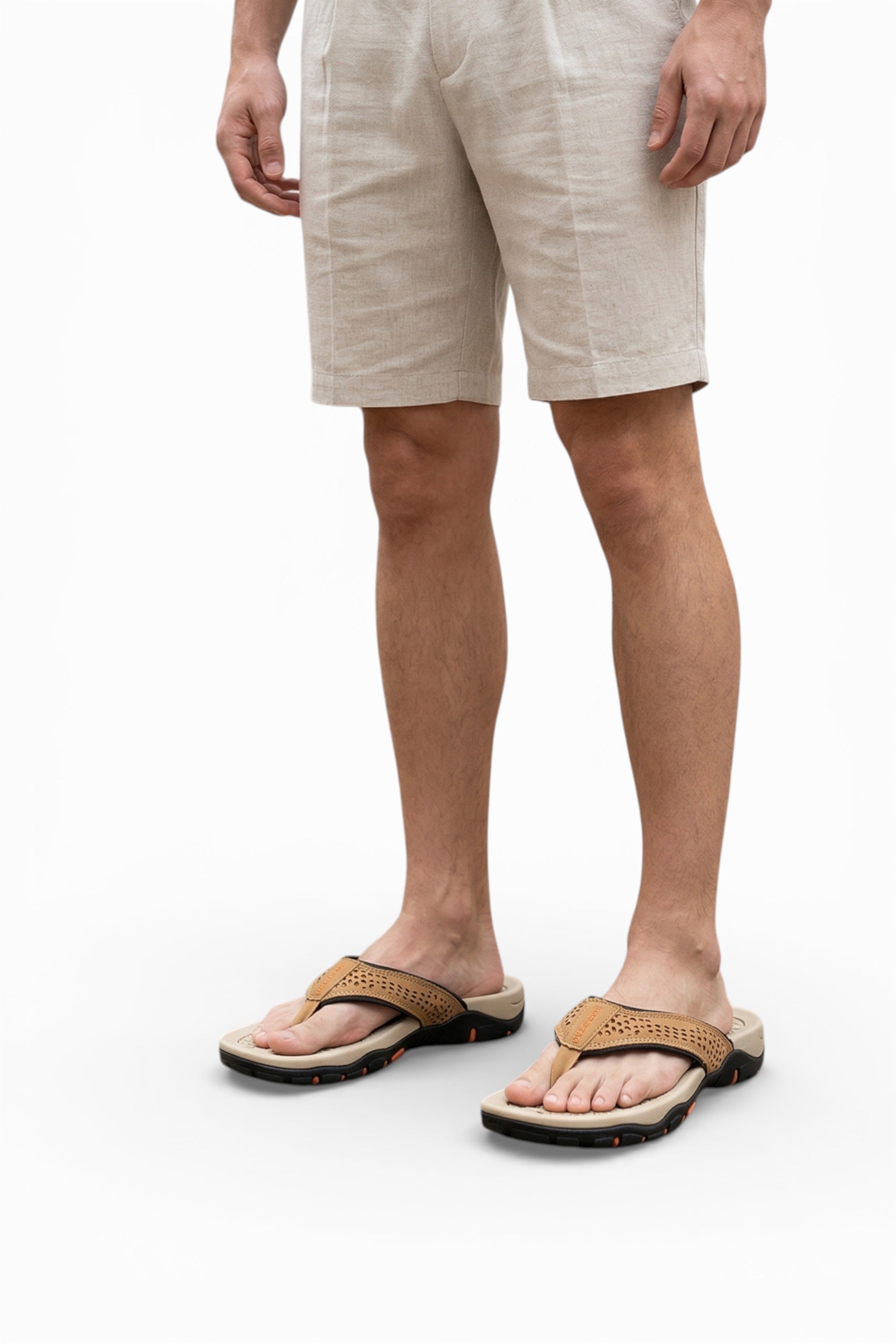 Person wearing beige shorts and sandals on a white background
