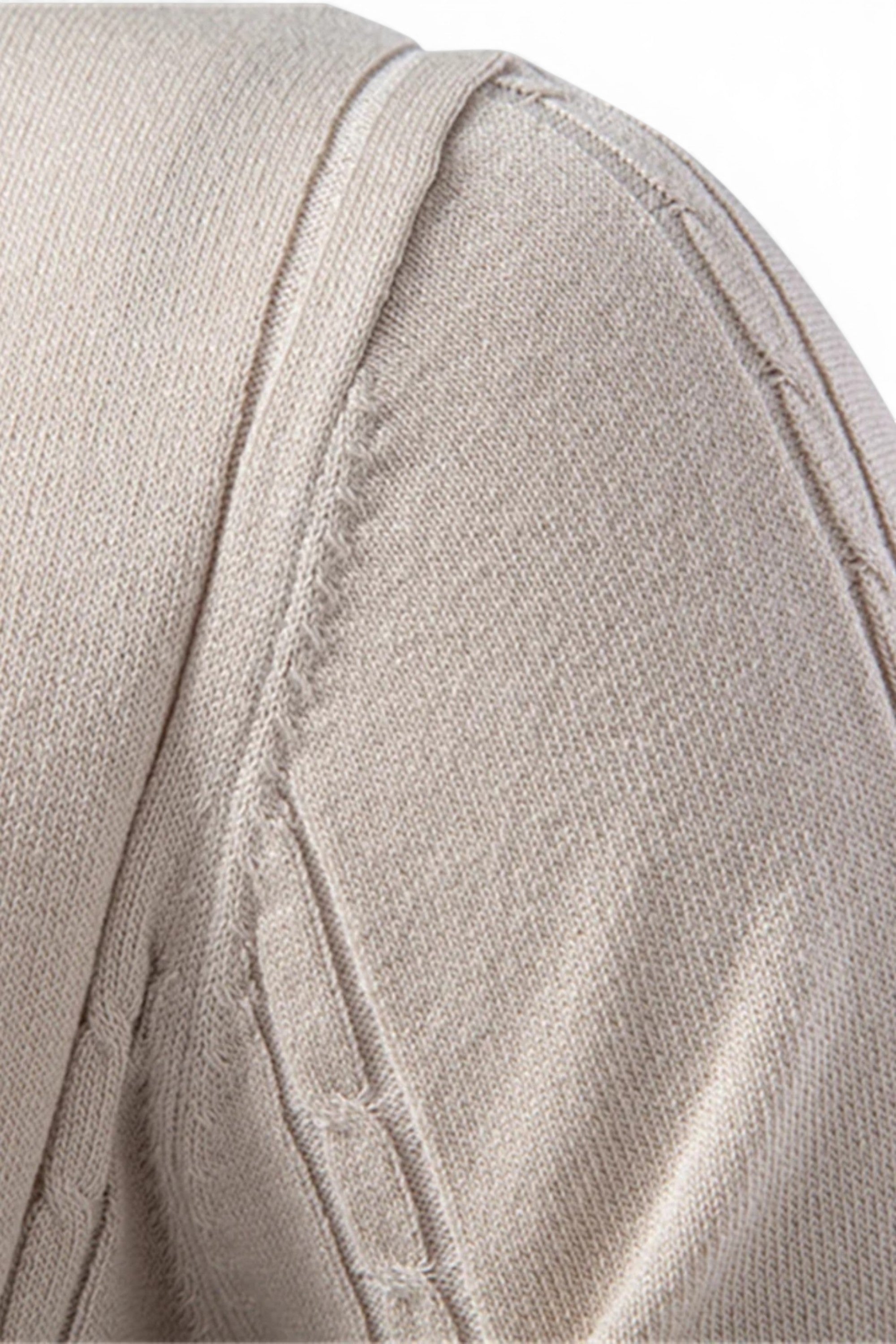 Close-up of beige fabric with stitching detail