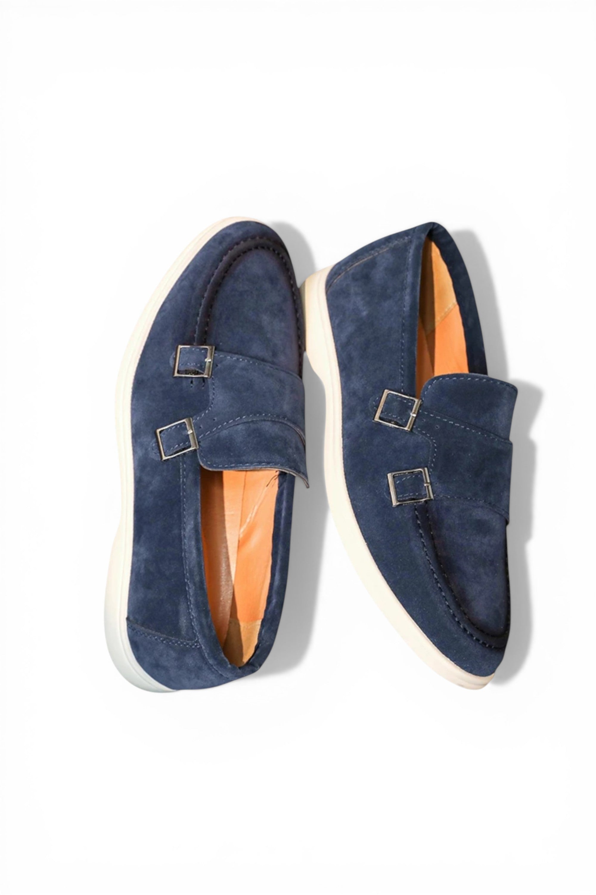 Pair of navy blue loafers with gold buckles on a white background