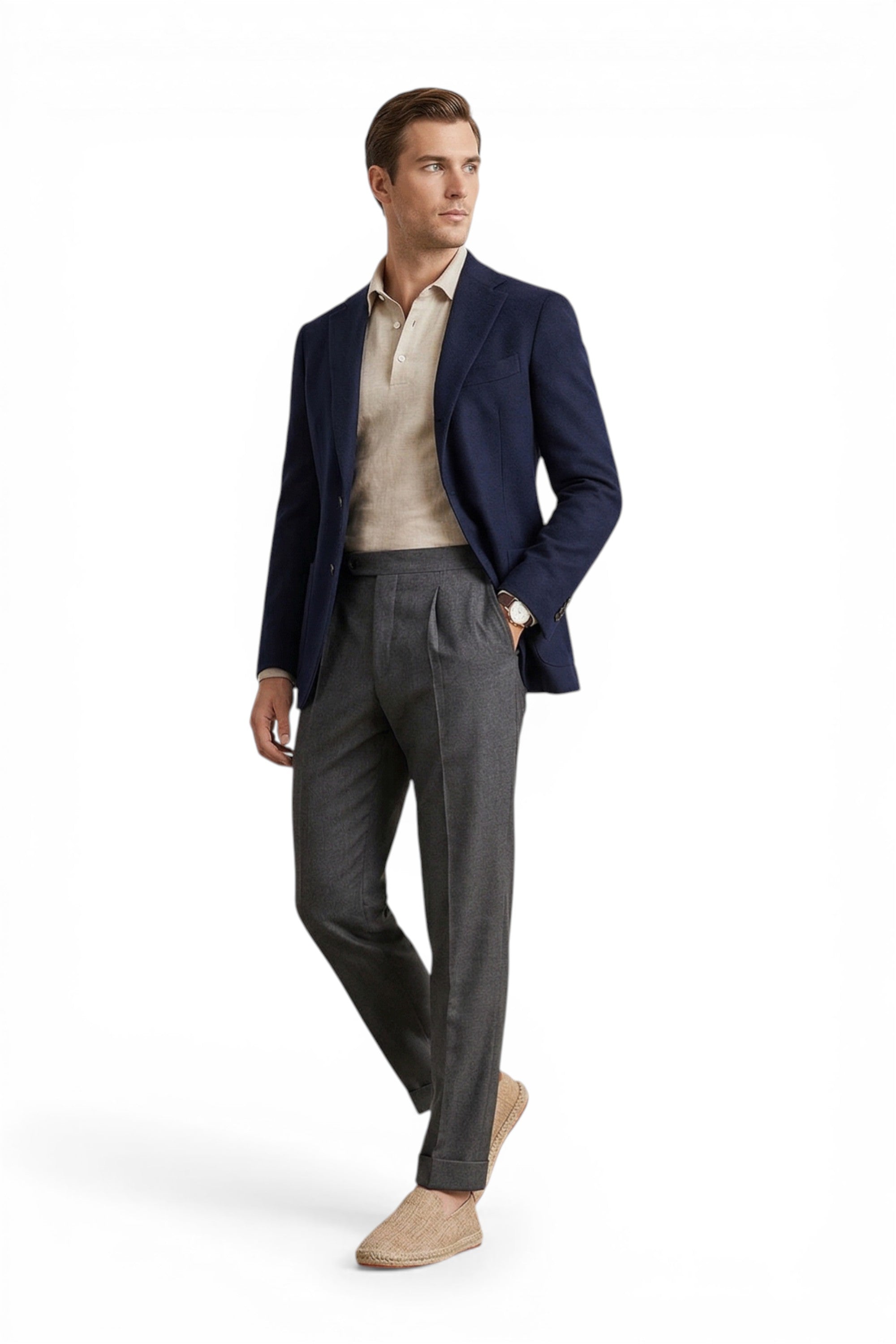 Man wearing a navy blazer, beige shirt, and gray pants on a white background