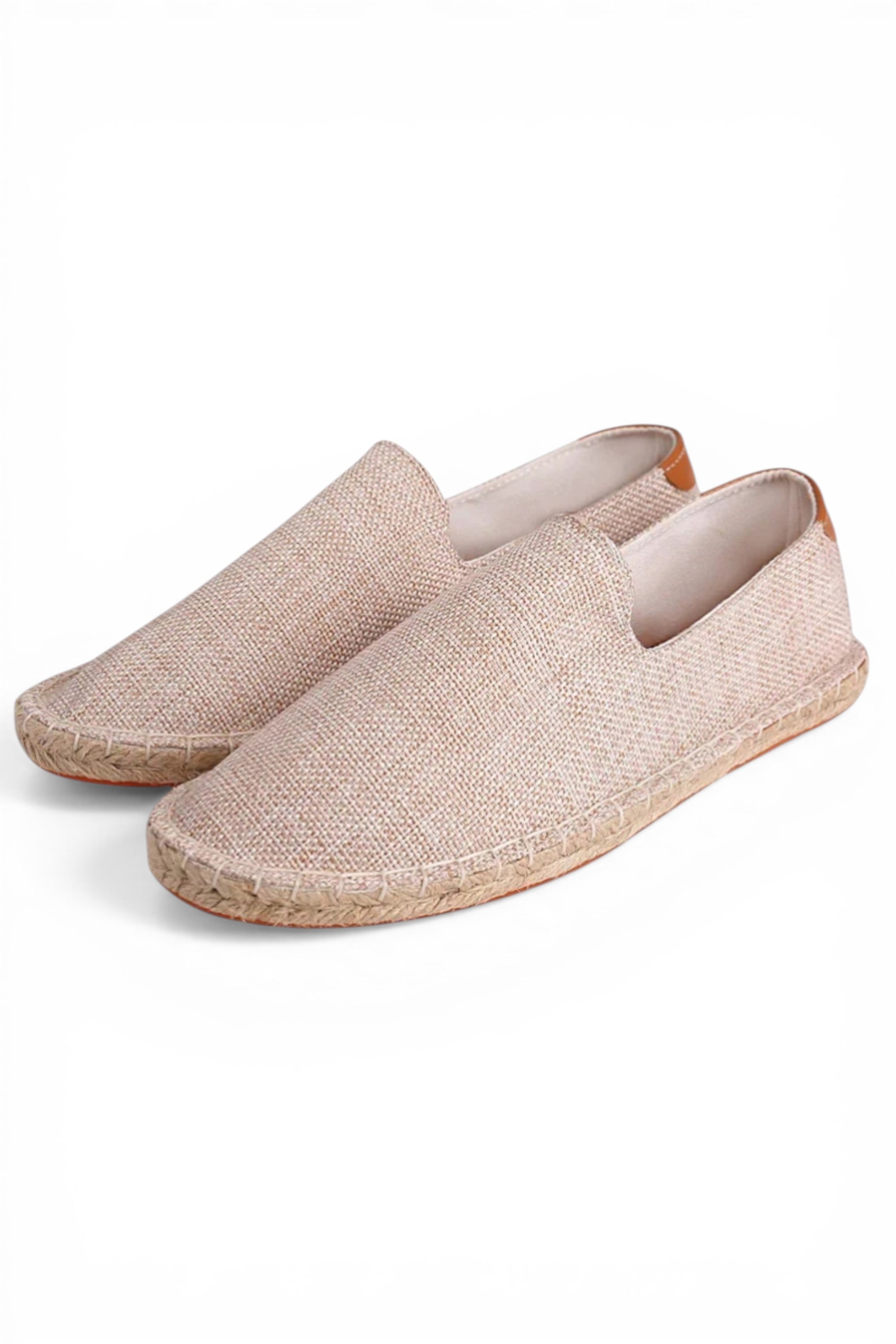 Pair of beige espadrille shoes on a white background