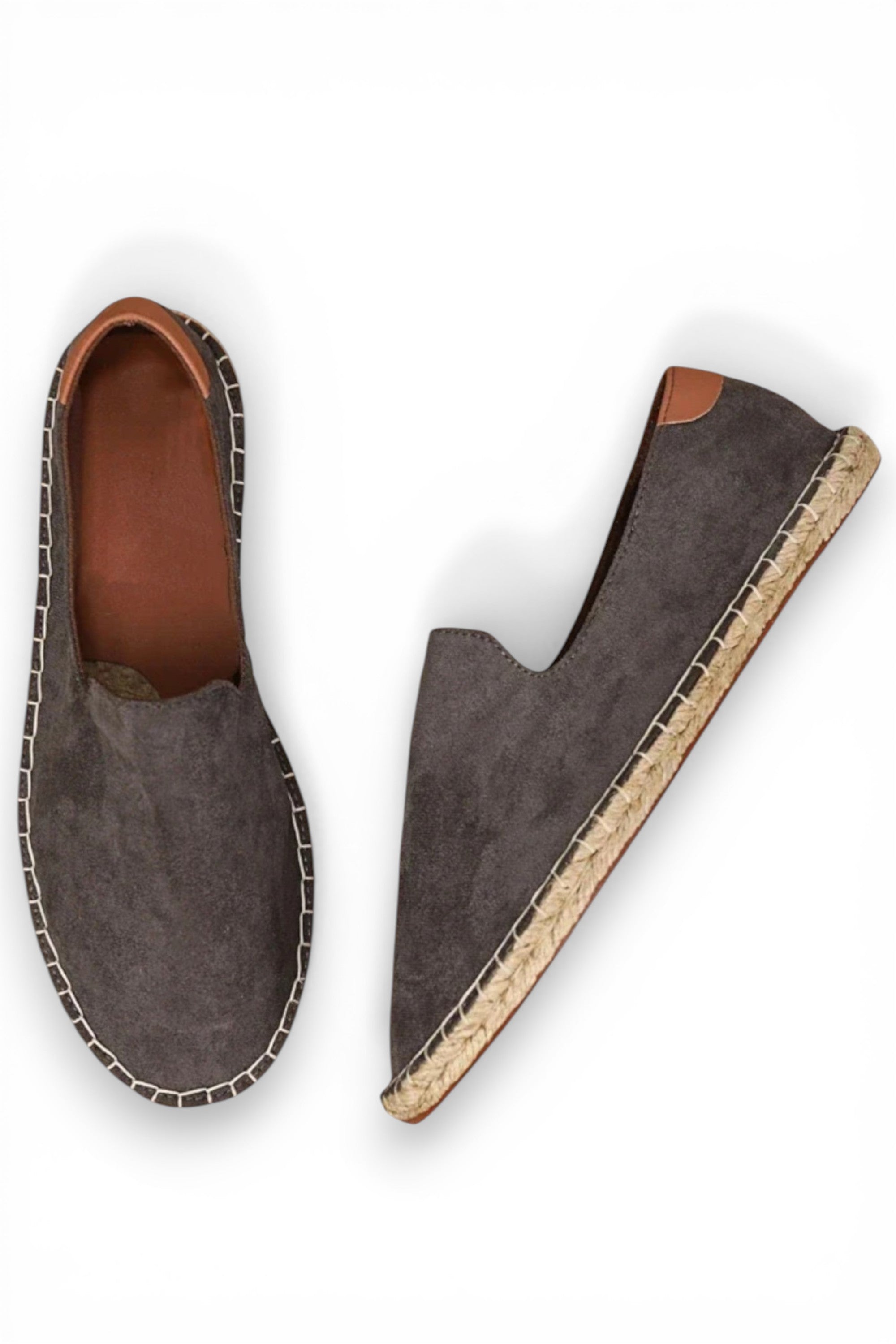 Pair of gray suede shoes with brown soles on a white background