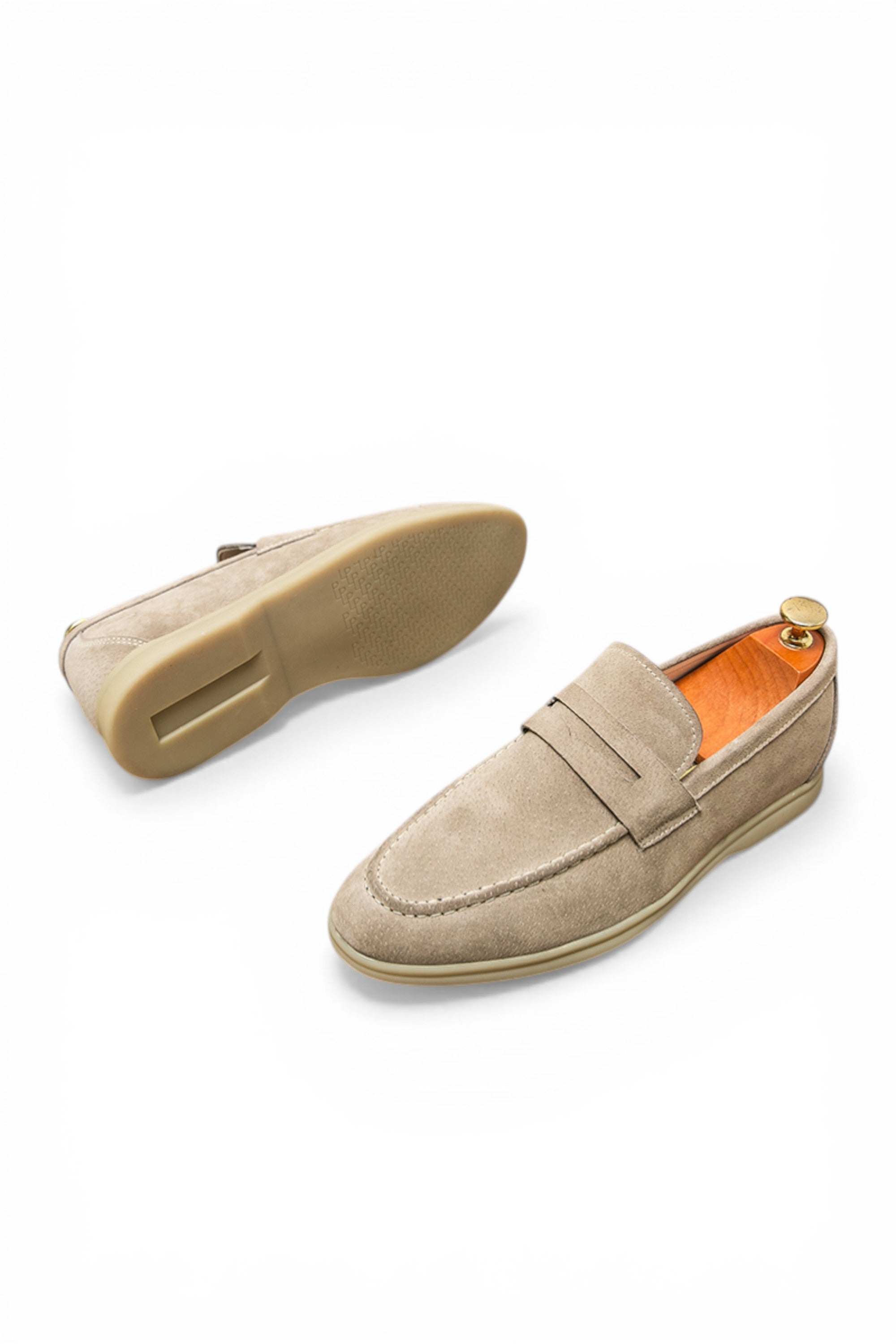 Beige loafers on a white background