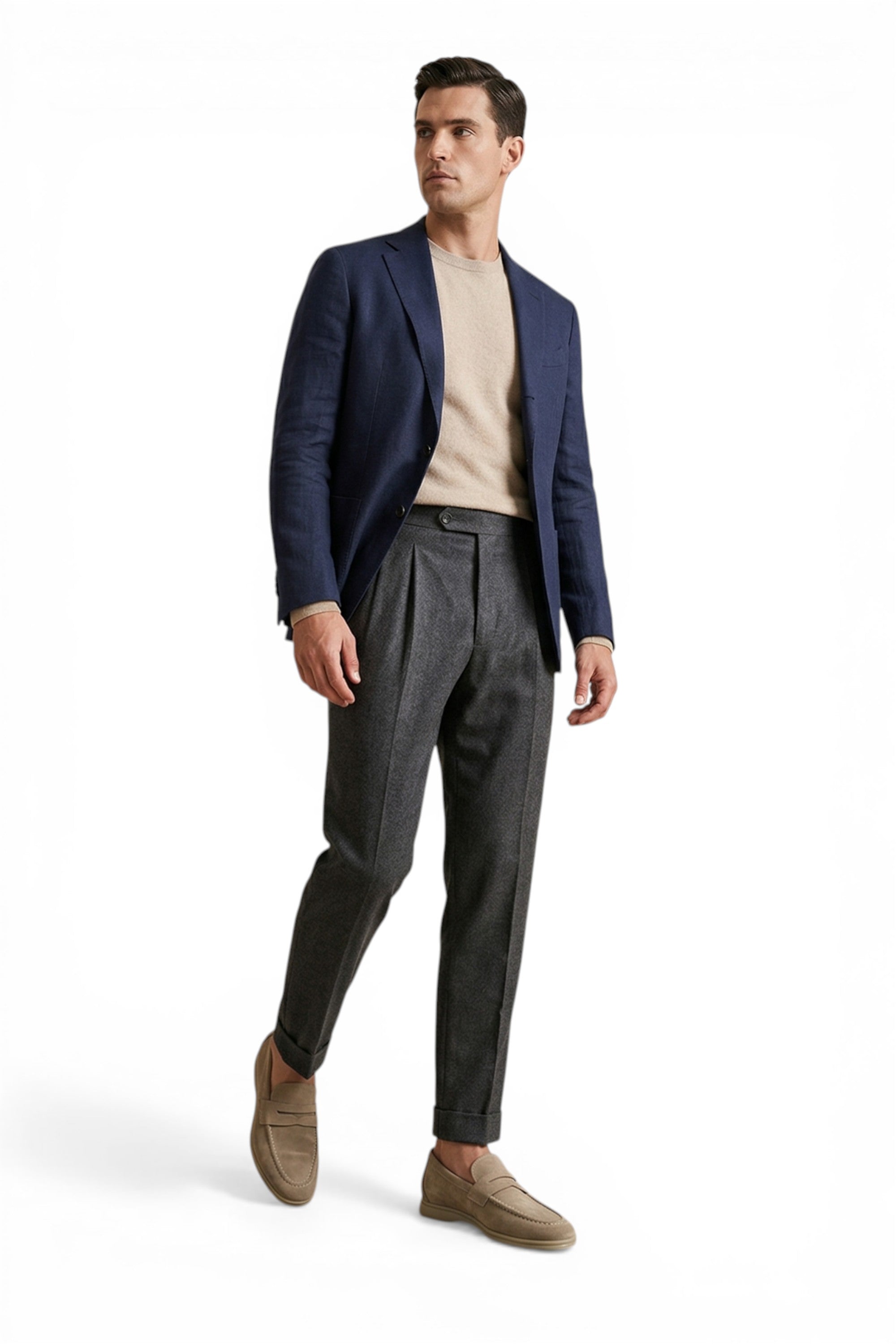 Man wearing a navy blazer, beige shirt, gray pants, and brown shoes on a white background