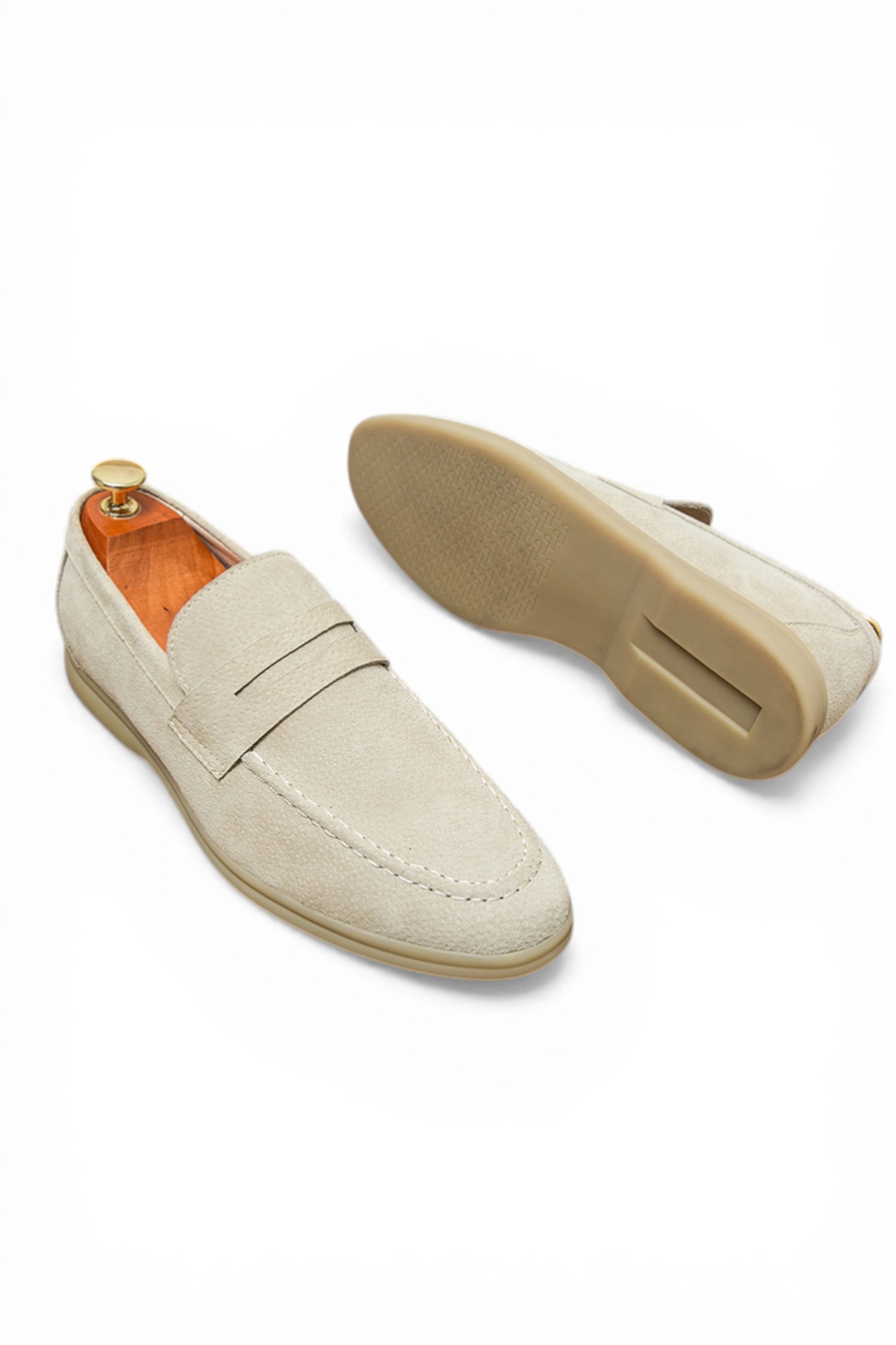 Beige loafer shoe with a white sole on a white background