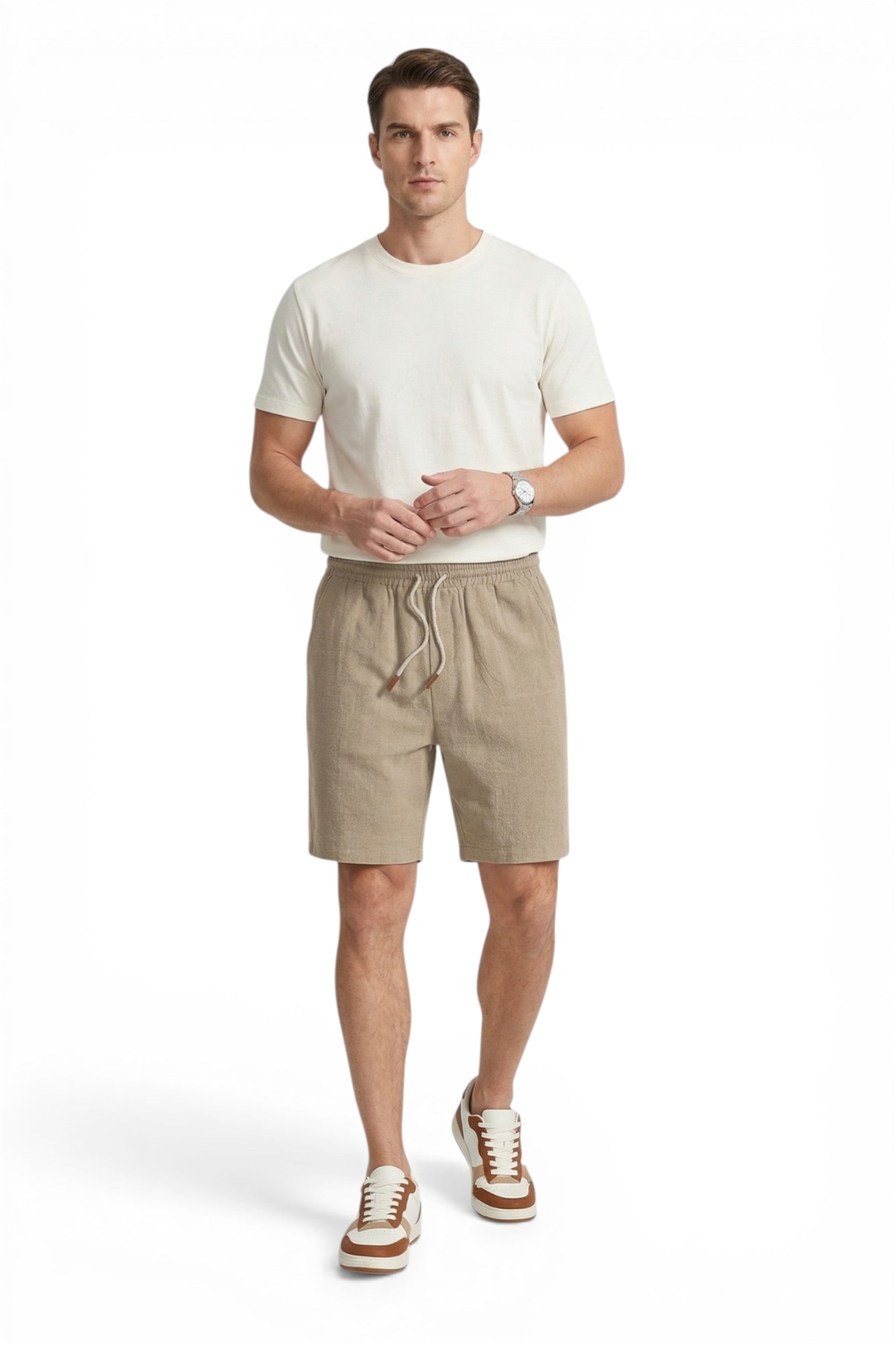 Man wearing a white t-shirt and beige shorts on a white background