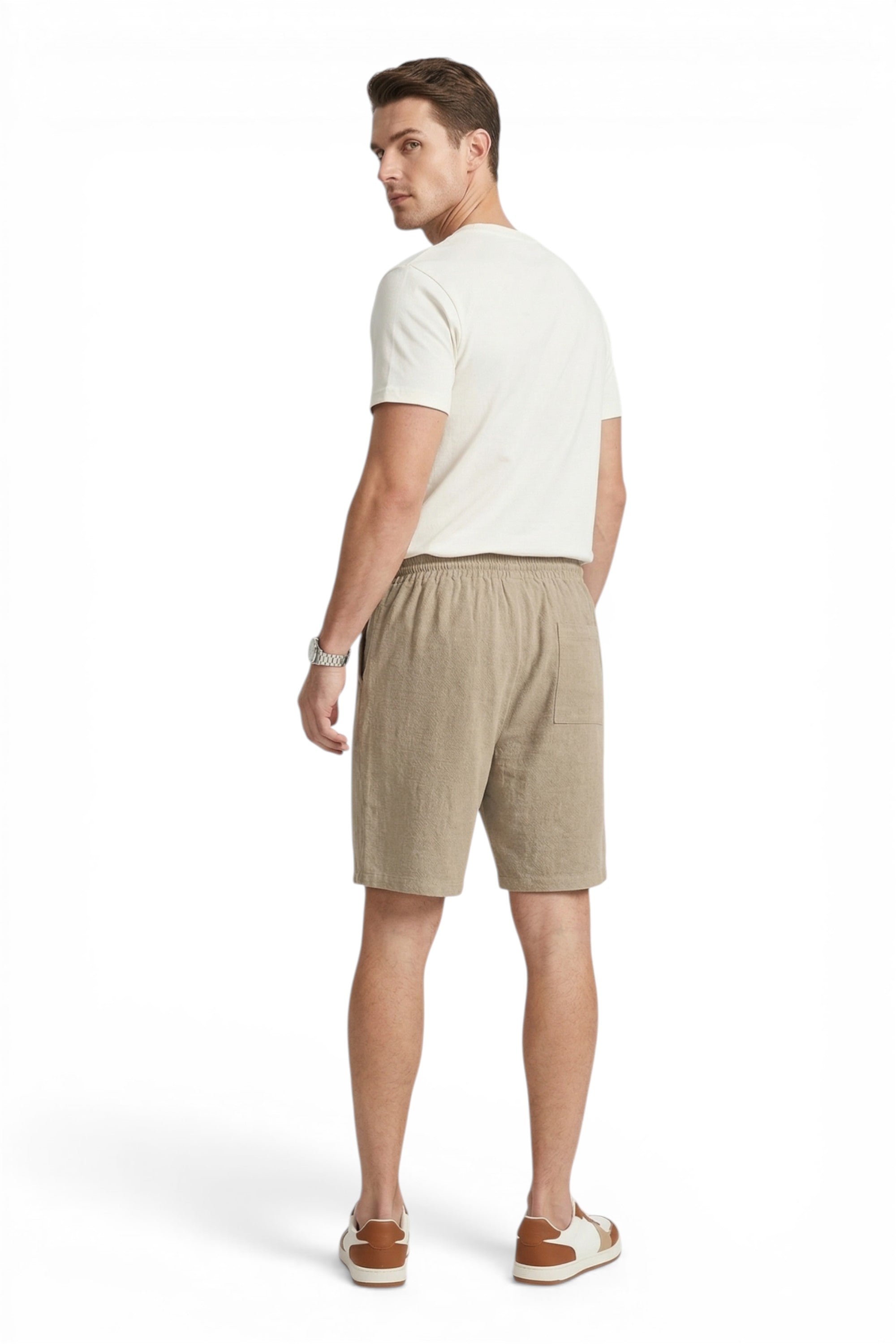 Man wearing a white t-shirt and beige shorts on a white background