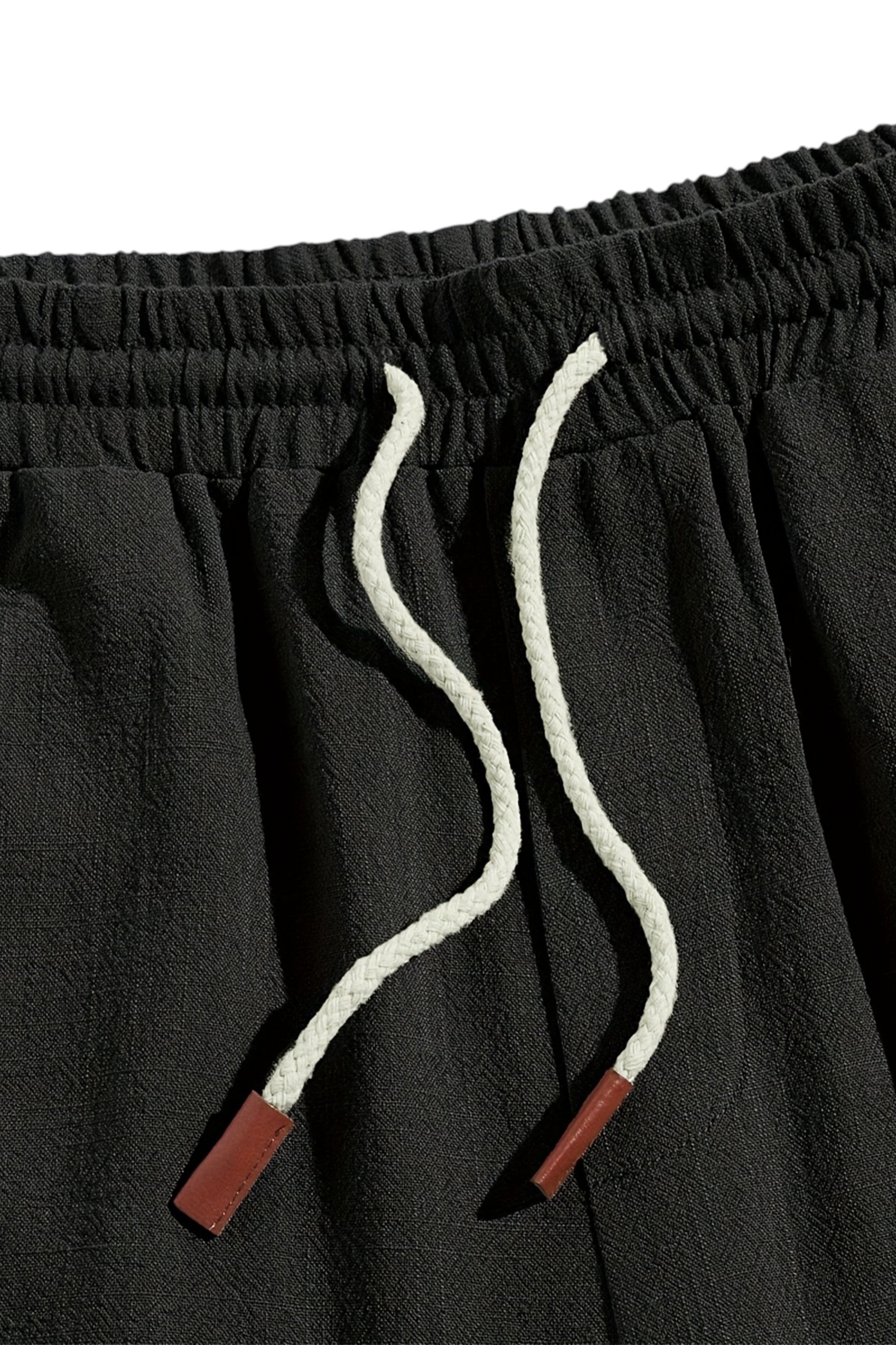 Black pants with white drawstring and red accents on a white background