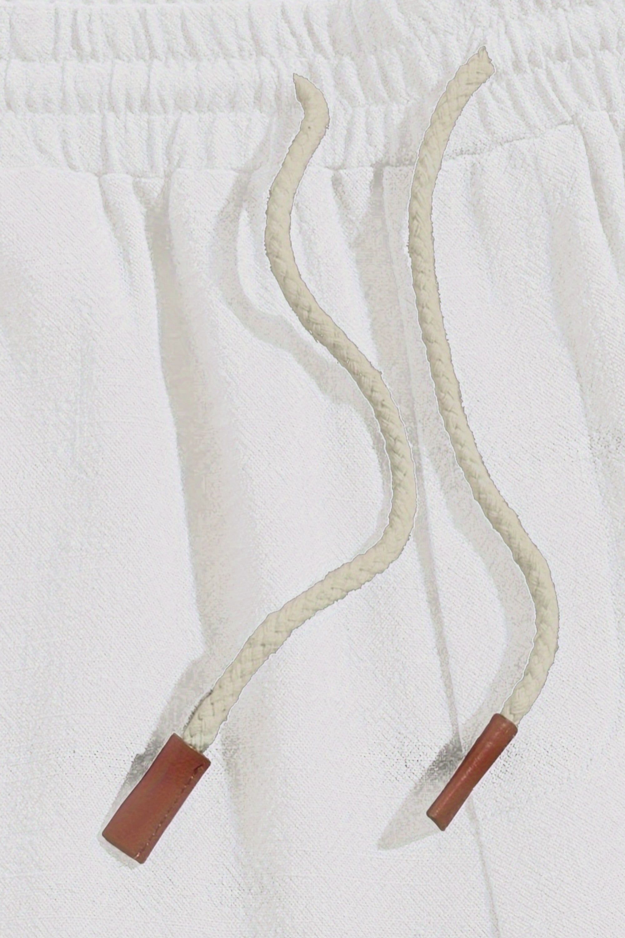 Two white lanyards with red ends on a white background
