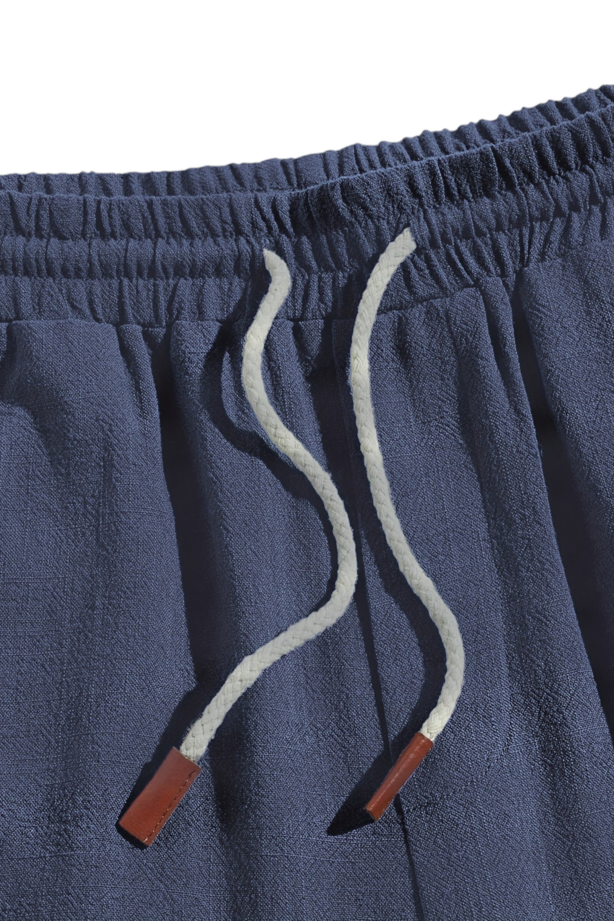 Close-up of blue shorts with drawstring and red accents on a white background