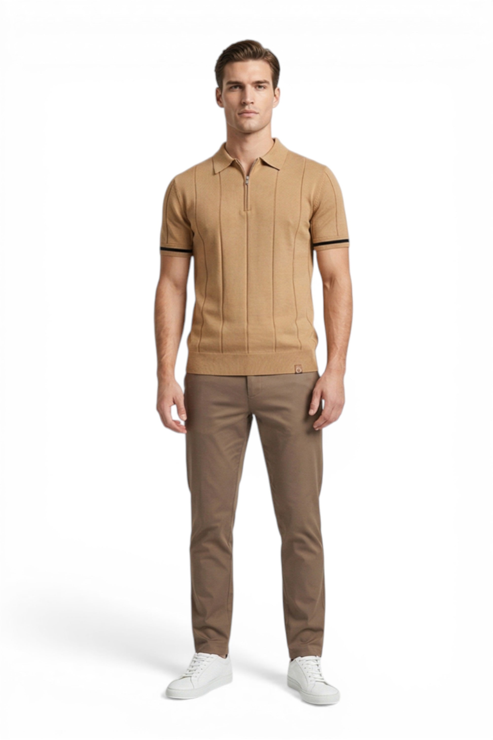 Man wearing a beige polo shirt and pants with white shoes on a white background