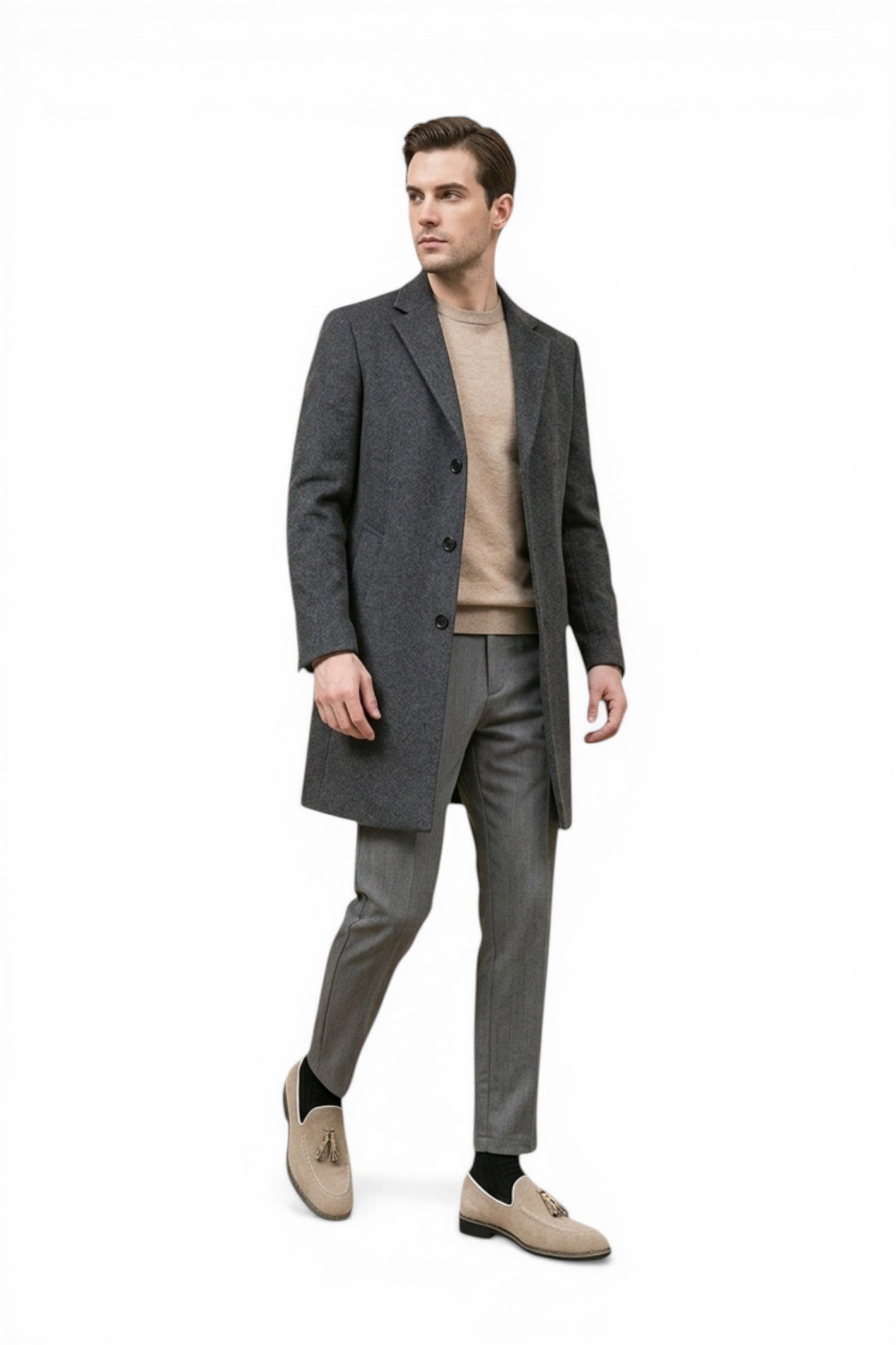 Man wearing a gray coat, beige sweater, and pants on a white background