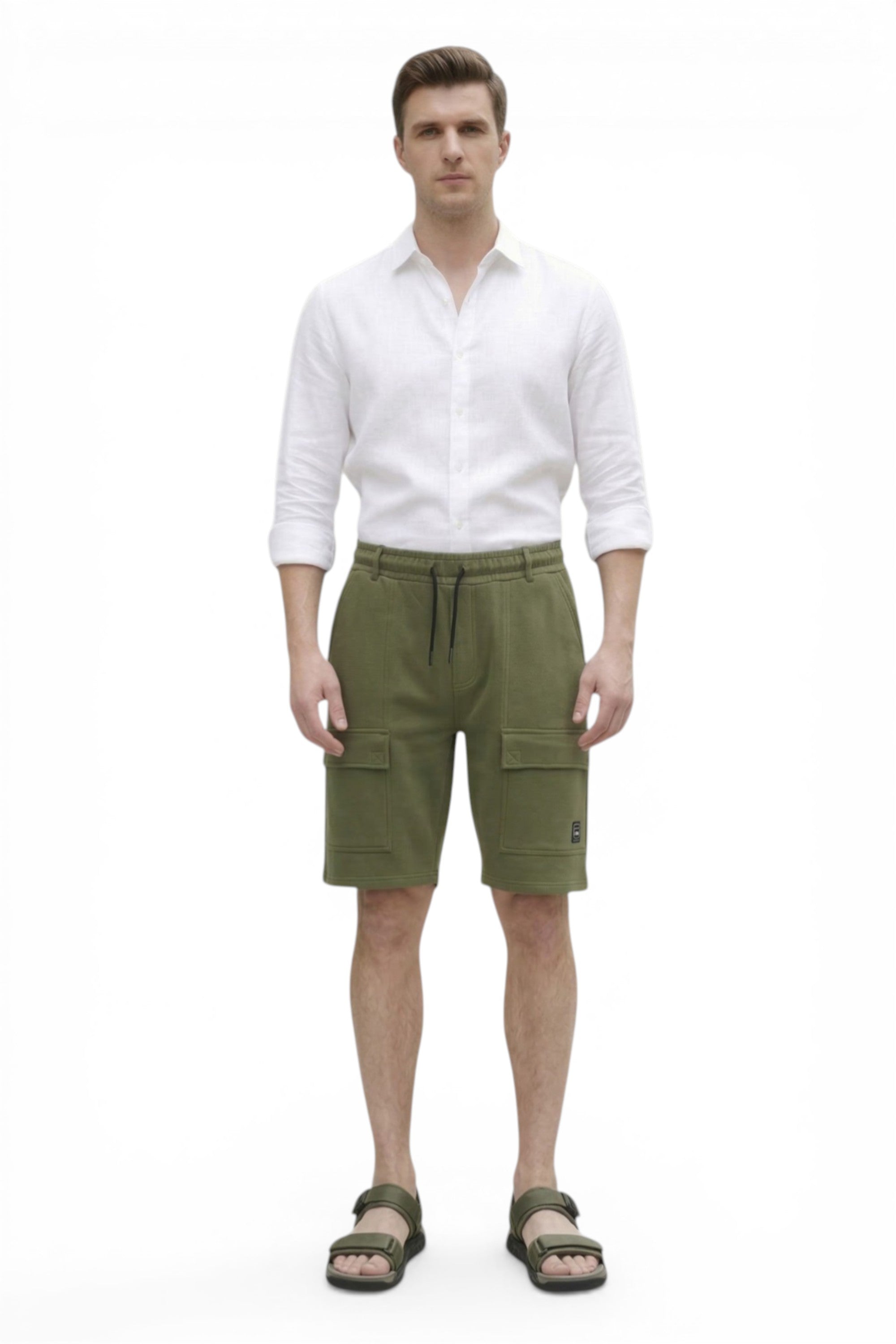 Man wearing a white shirt and green cargo shorts on a white background