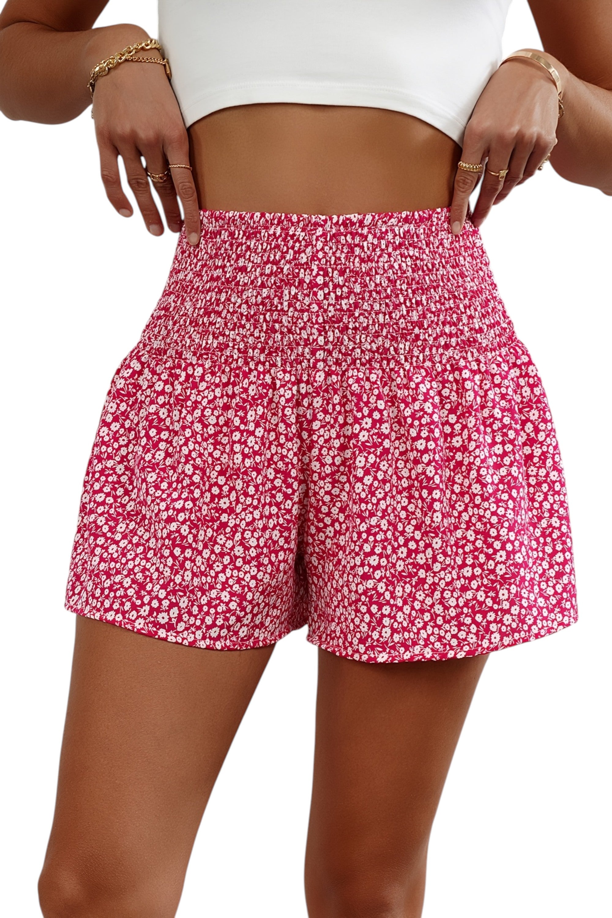 Person wearing pink floral shorts on a white background