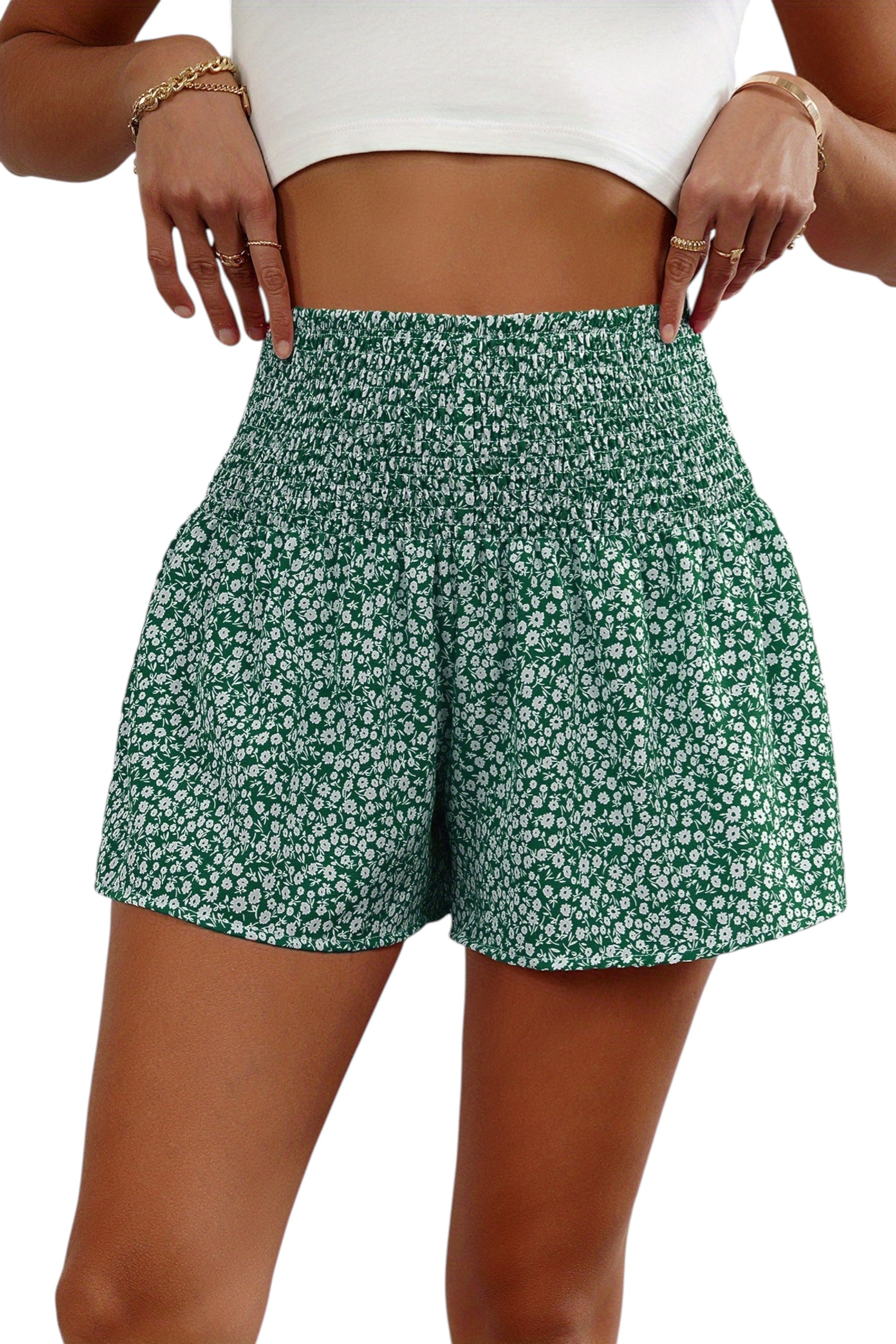 Green floral shorts worn by a person on a white background