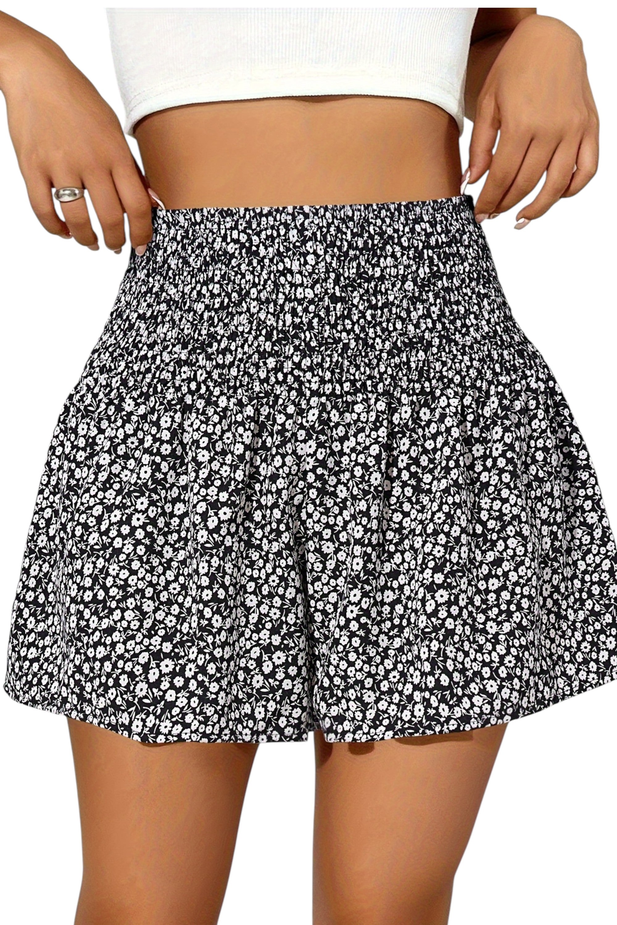 Black and white floral patterned skirt worn by a person on a plain background