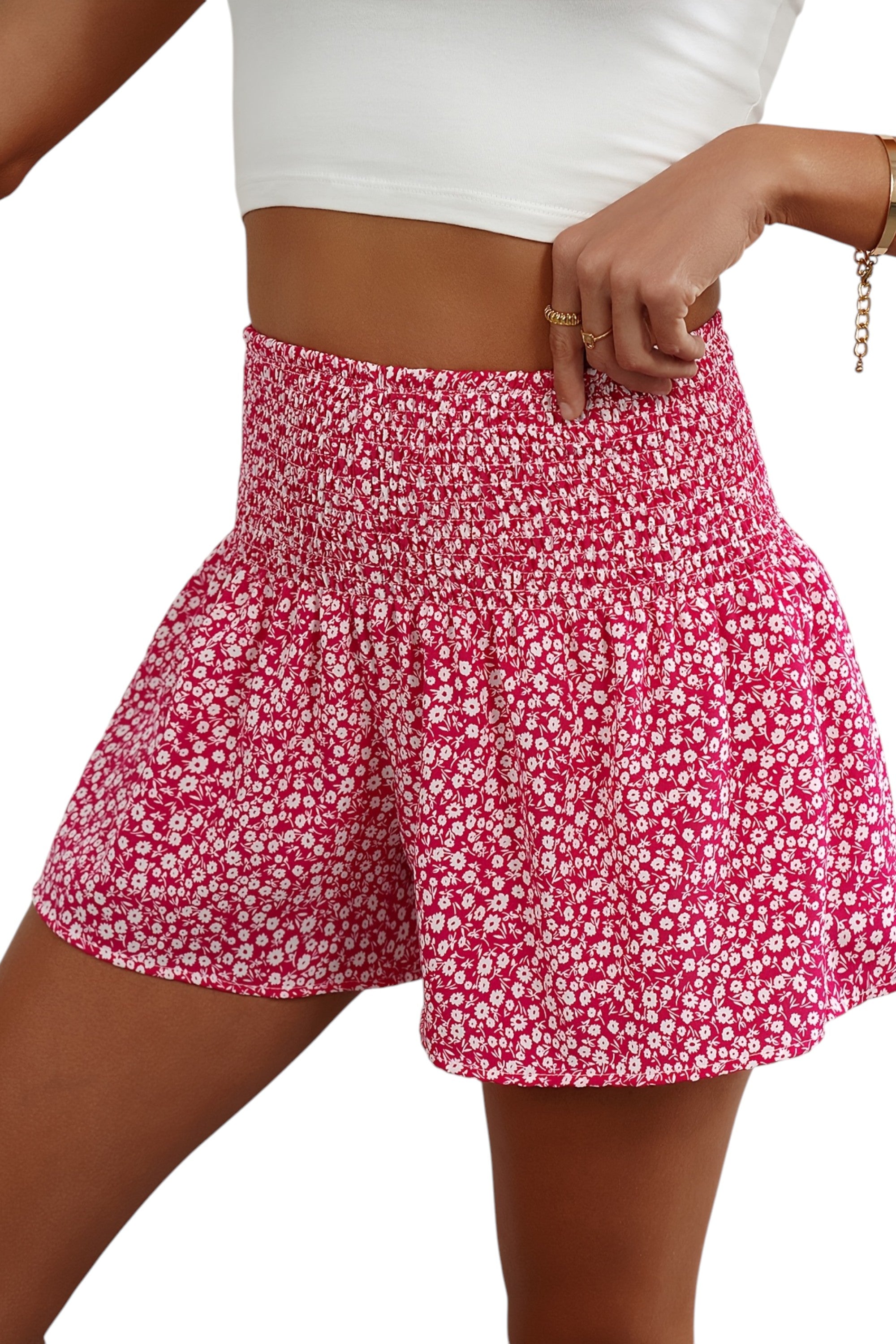 Person wearing a pink floral skirt on a white background