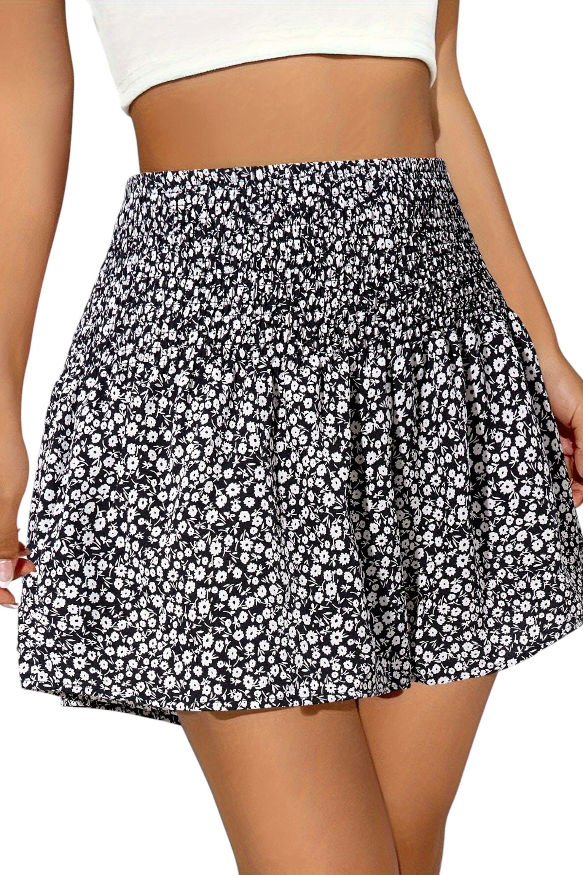 Black and white floral skirt worn by a person on a white background