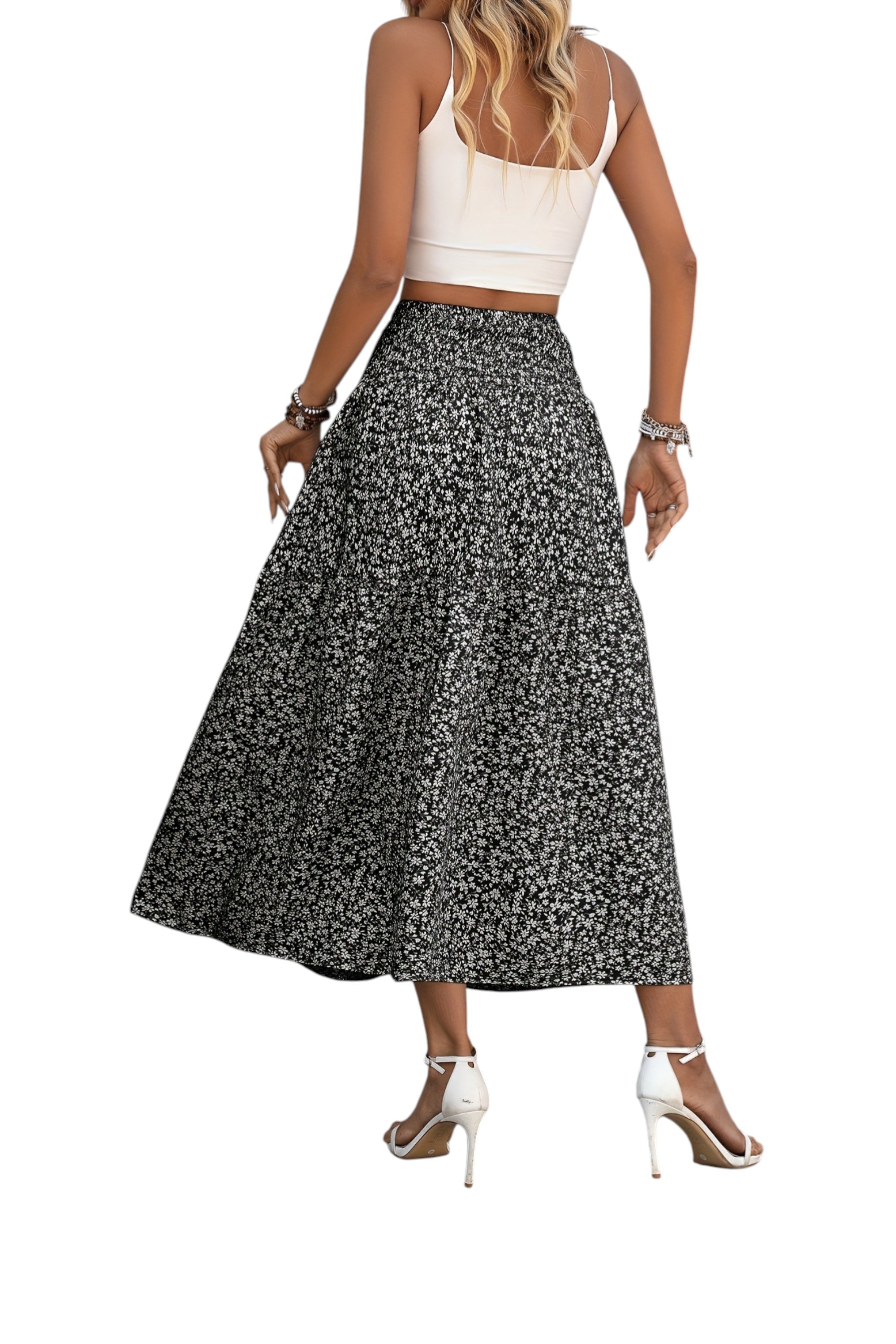 Woman wearing a white top and black floral skirt on a white background