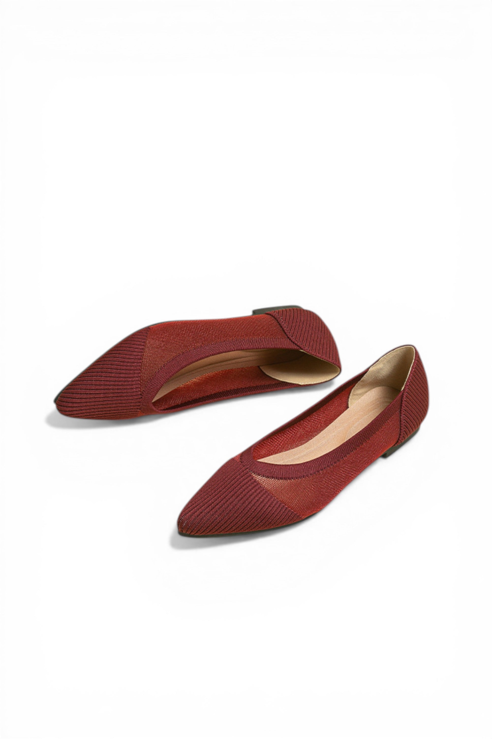 Pair of red pointed-toe flats on a white background