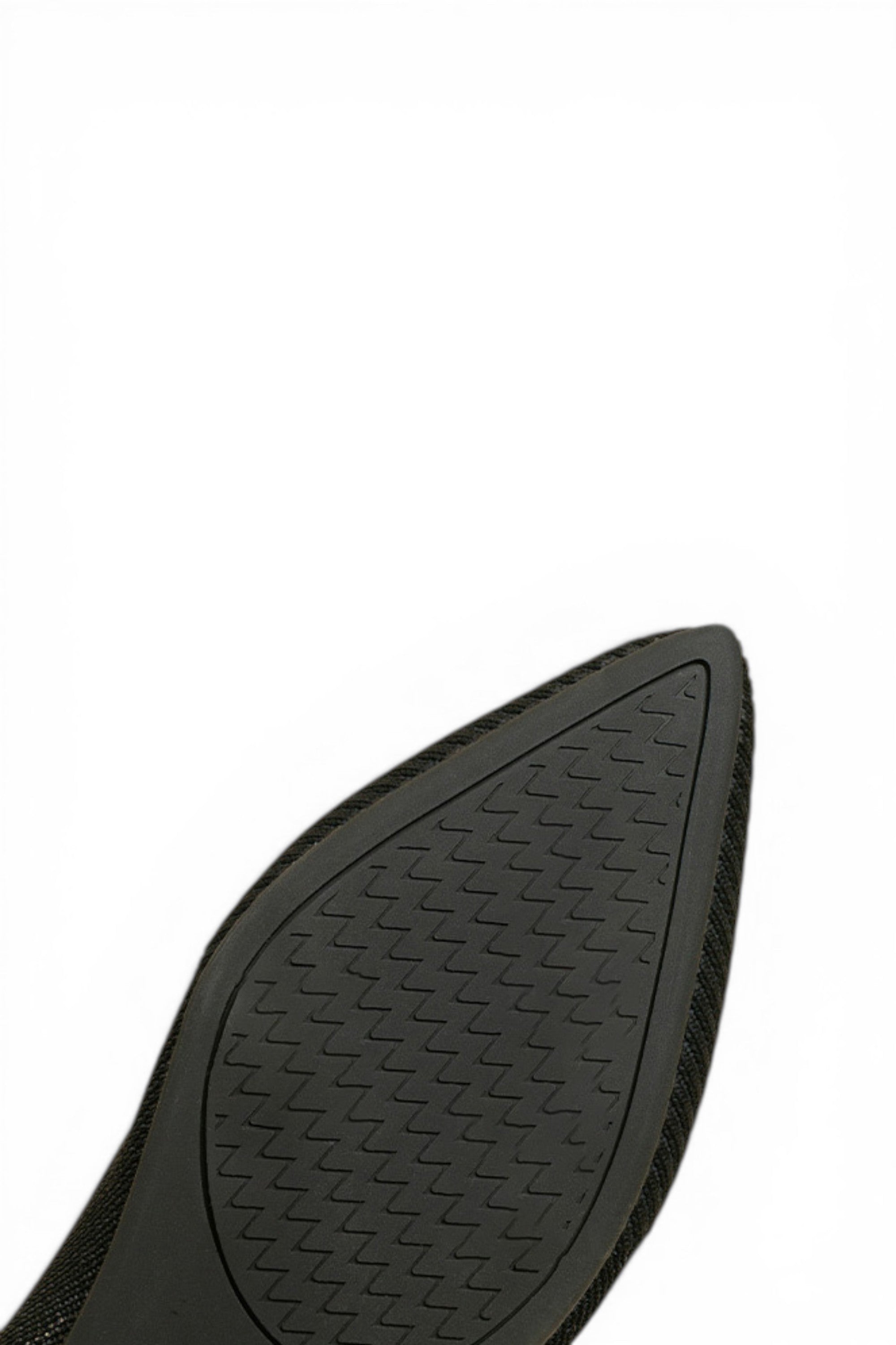 Black shoe sole with tread pattern on a white background