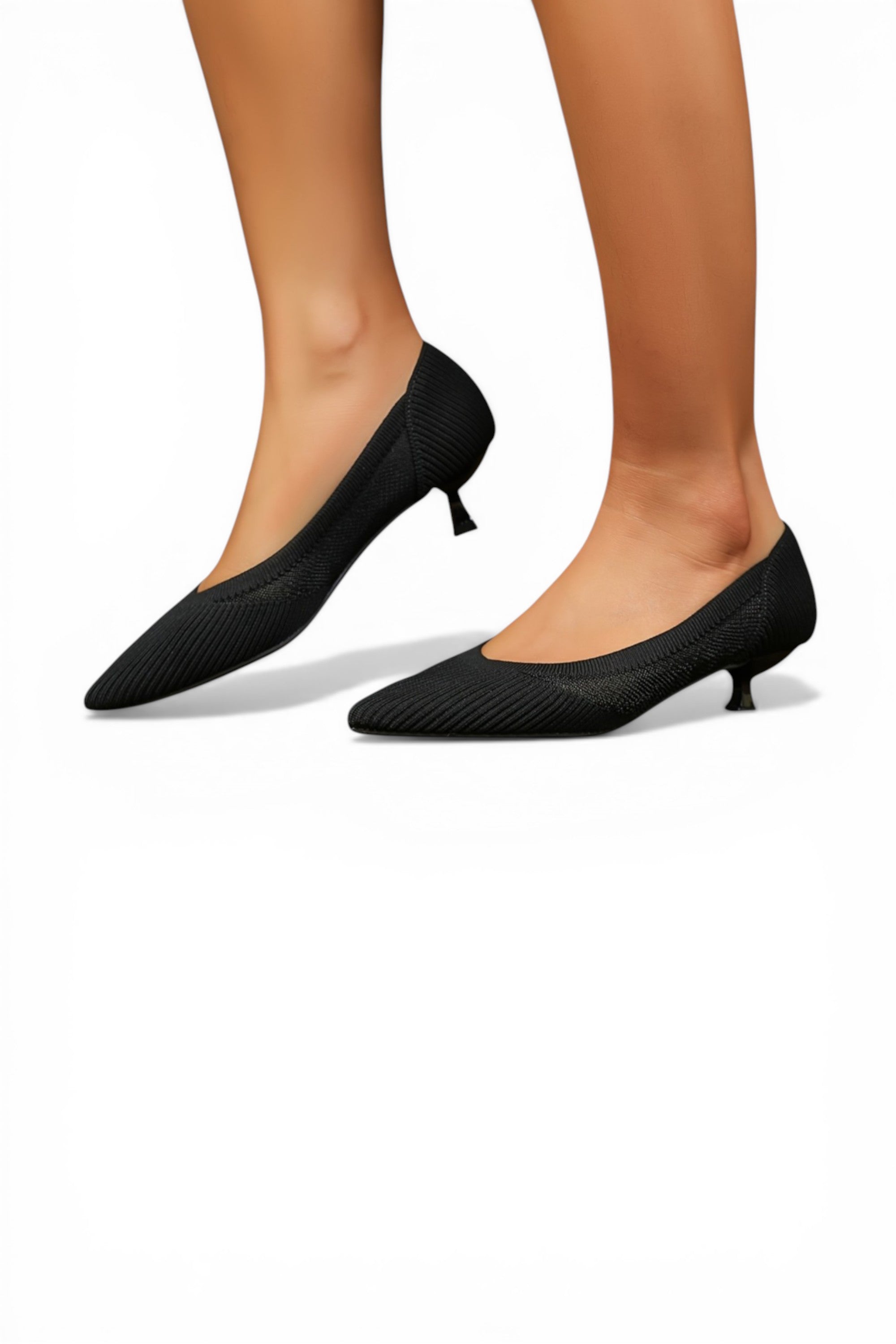 Black high-heeled shoes worn by a person on a white background