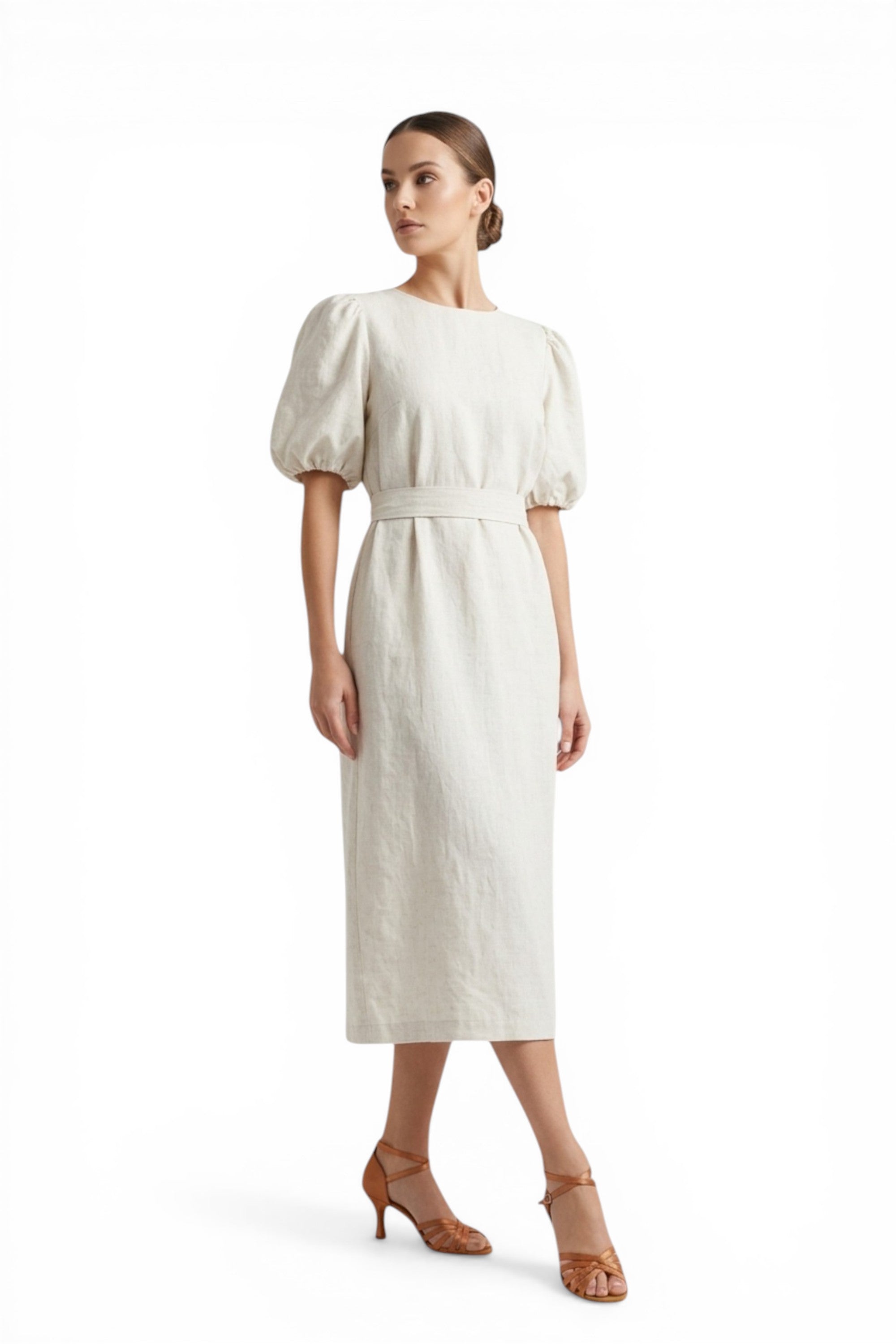 Woman wearing a white dress with puff sleeves on a white background