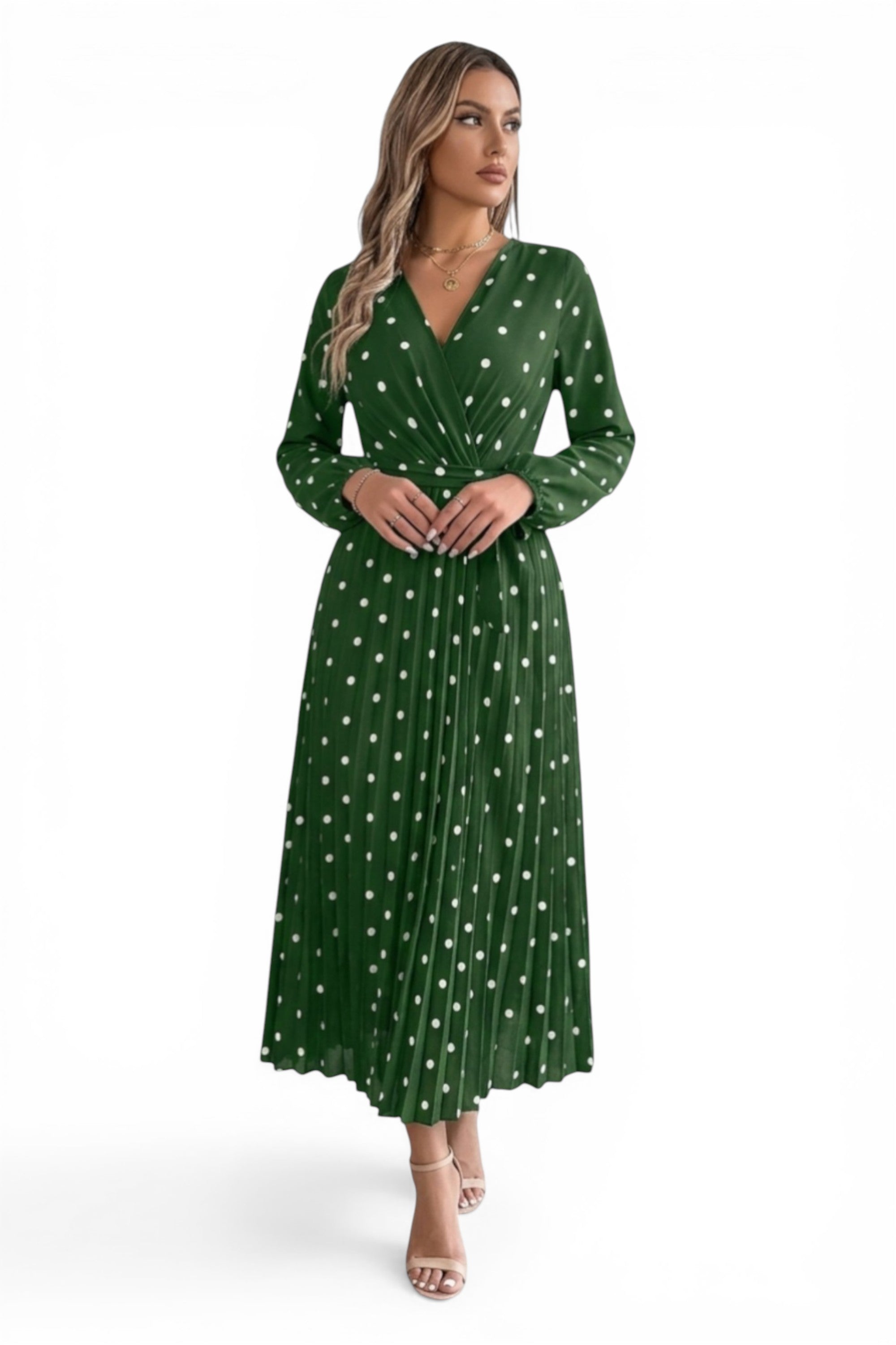 Woman wearing a green dress with white polka dots on a white background