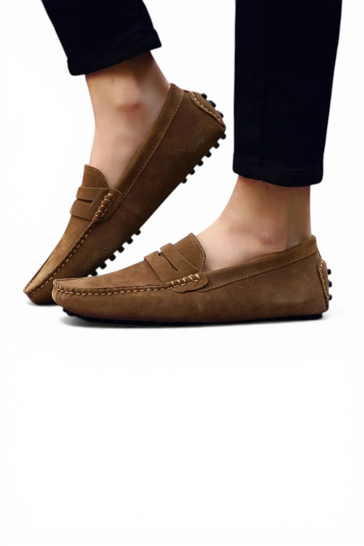 Brown loafers worn with black pants on a white background